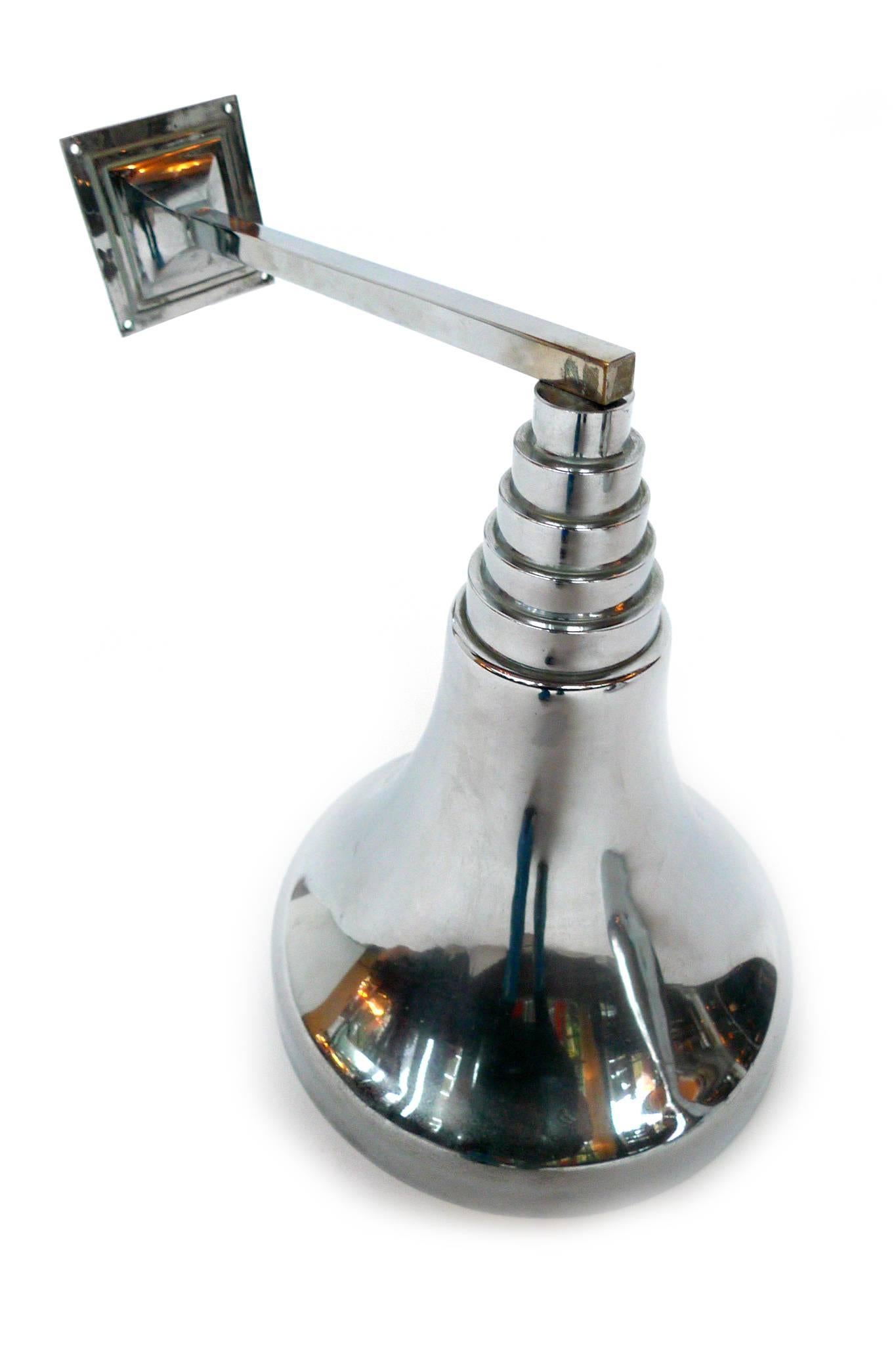 These Art Deco-style chrome sconces have a tiered shape. Their design includes a 13 1/4