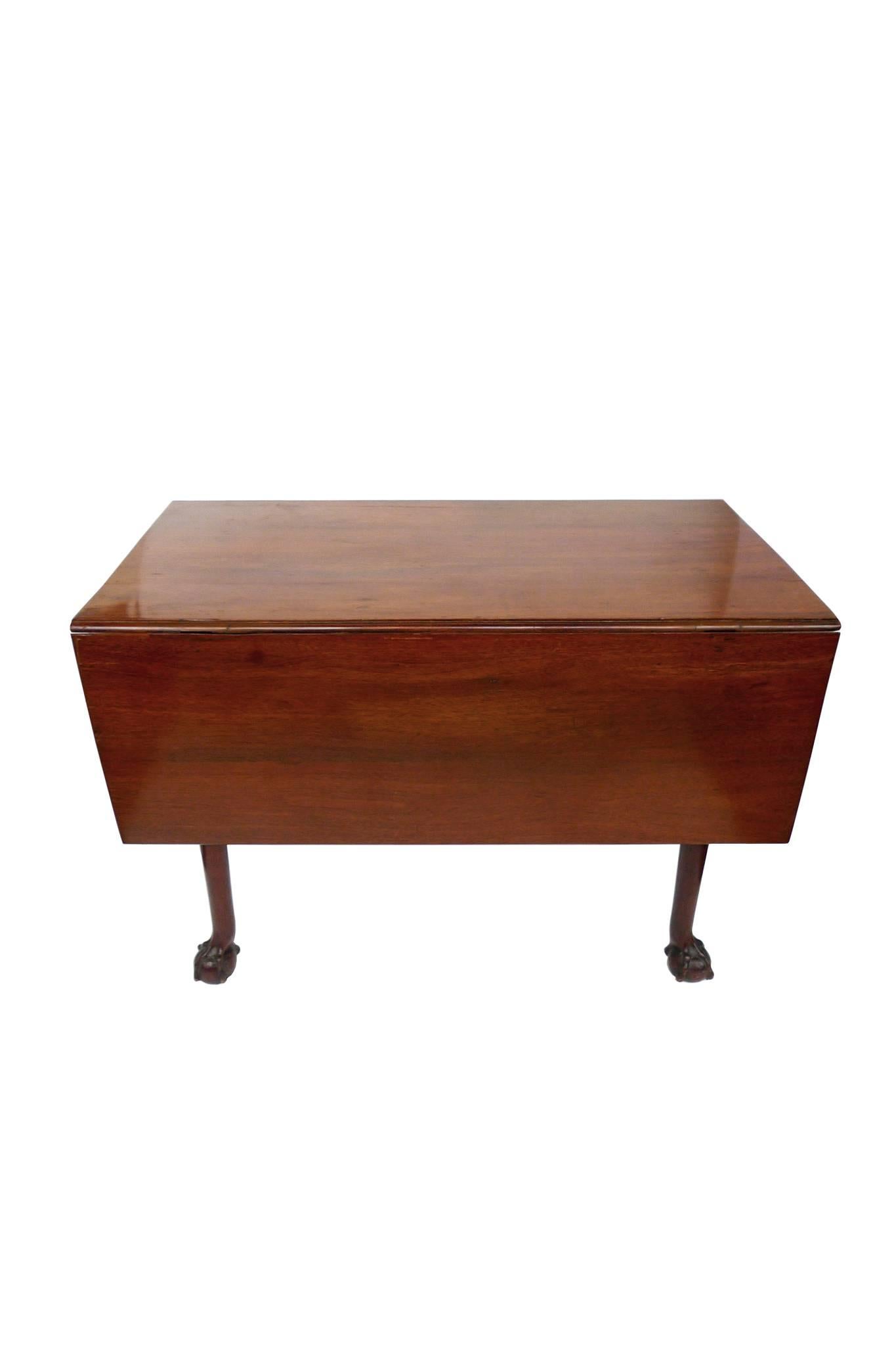 This English Chippendale drop-leaf table is mahogany and was created, circa 1760-1780. The mahogany is a rich honey brown and well-aged. There are two drop leaves, each measuring 15.5 inches. With both leaves unfolded, the table's depth extends to