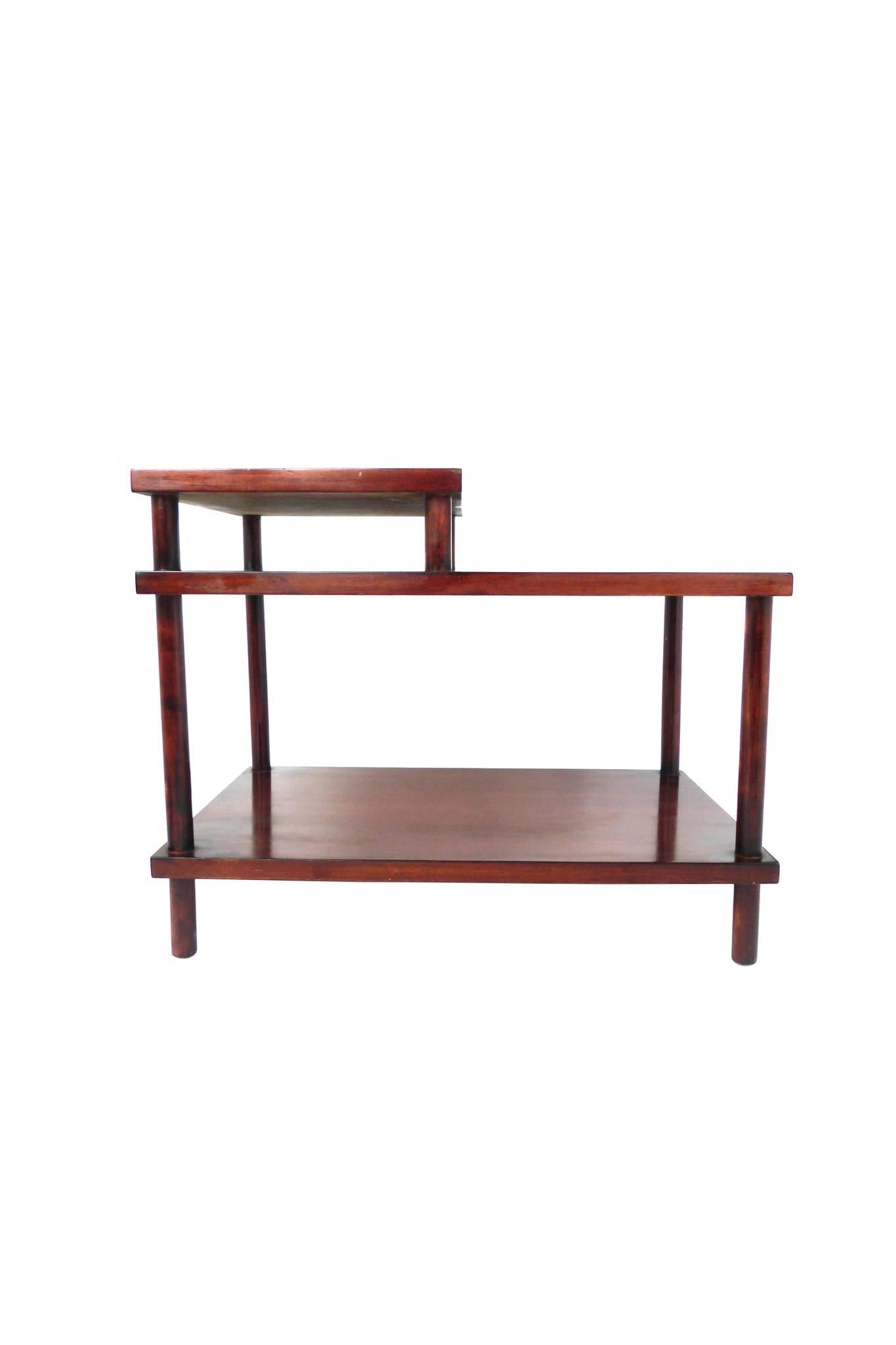 This lacquered side table was designed by T.H. Robsjohn-Gibbings for Widdicomb. It has a beautiful dark-red finish. Its clean lines and planes accentuate the classicism for which Robsjohn-Gibbings was renowned.
 