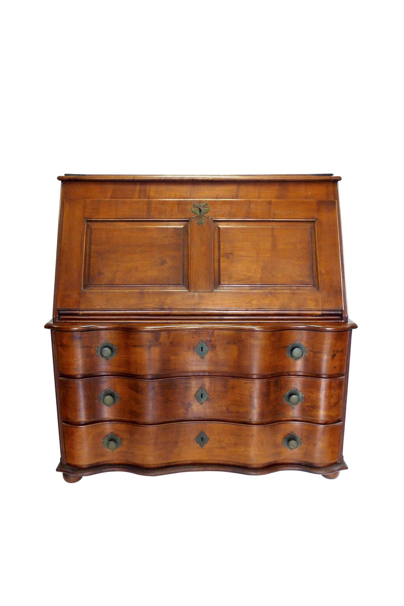 This 19th Century Swiss case piece is comprised of a drop-leaf desktop and a chest of drawers. They are a combination of cherry and pine wood. The brass hardware is original and includes a pair of keys. It's a sturdy, solid piece with ample storage