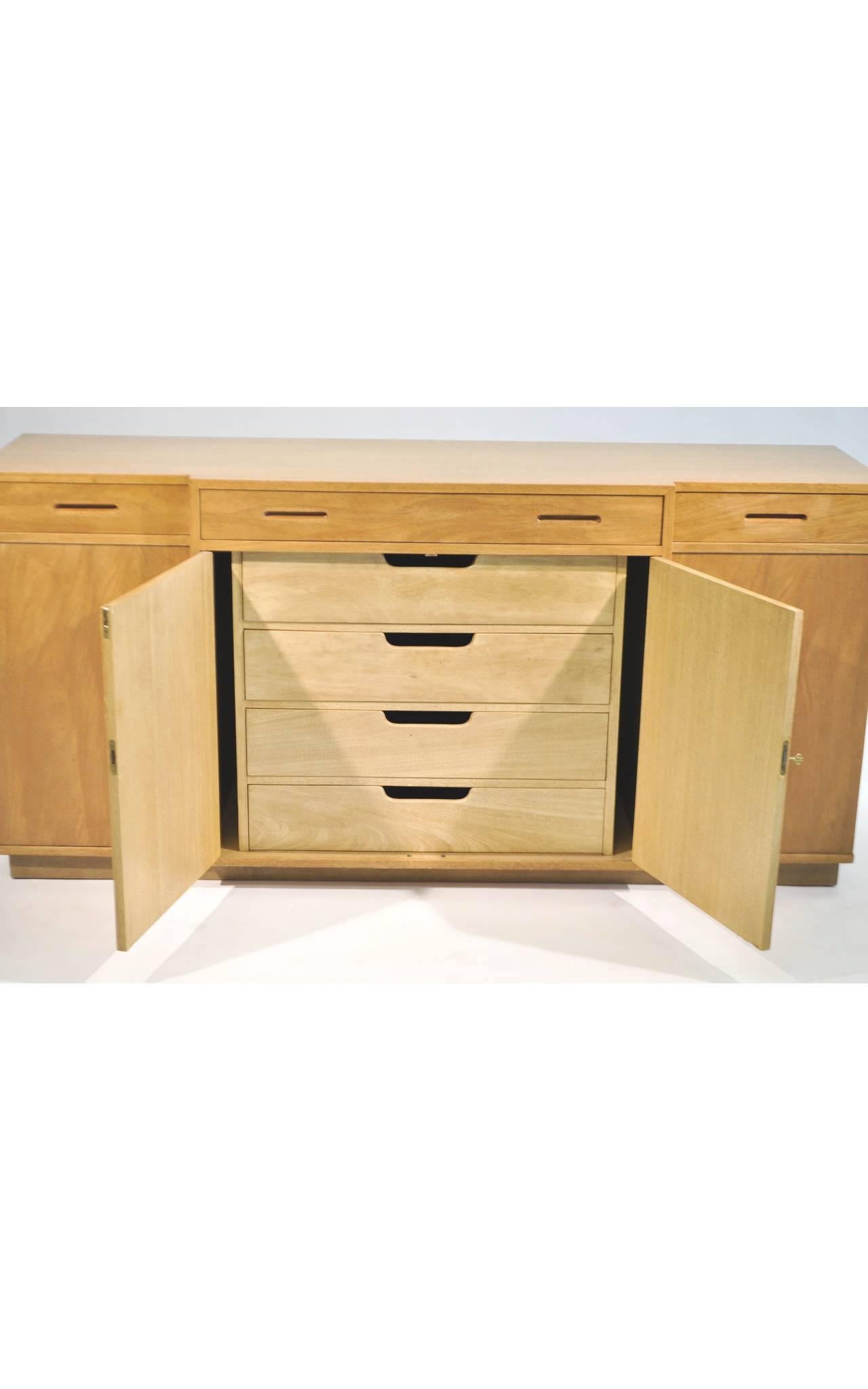 This exceptional sideboard was designed by Edward Wormley for Dunbar's New World Collection. Wormley's modernist design can be characterized as making use of simple surfaces and silhouettes while exemplifying fine woodwork. 

This sideboard is
