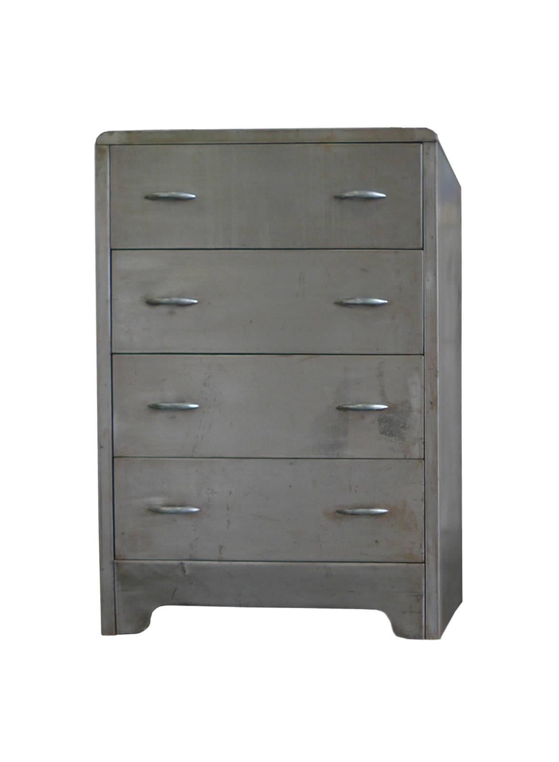 This industrial chest of drawers or dresser is comprised of polished steel. It's in the style of American designer Norman Bel Geddes renowned for his streamlined and Futurist designs with hints of Art Deco. The dresser combines rounded edges and