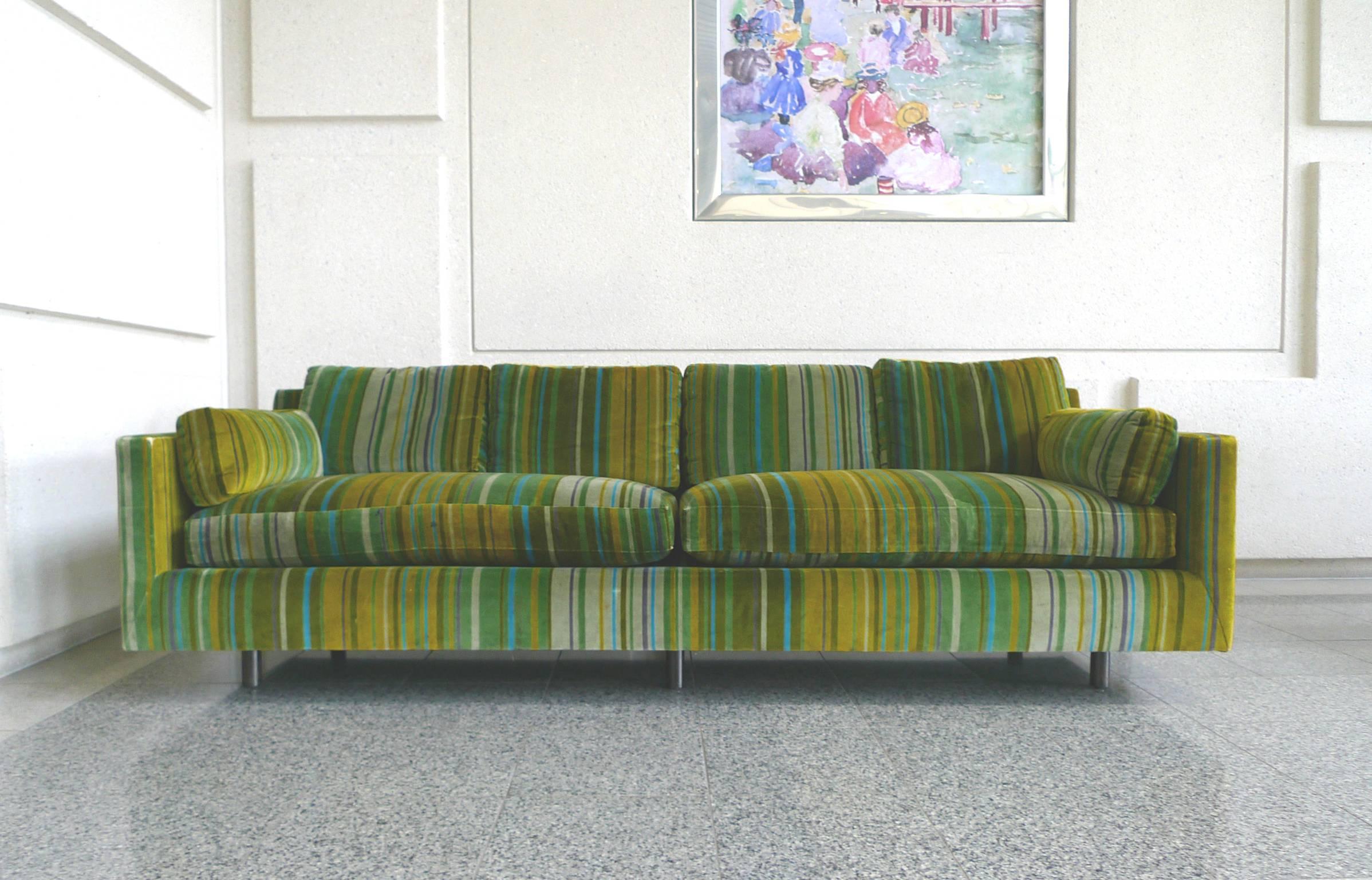 These Mid-Century Modern sofas were designed by Harvey Probber. The lines are simple and spare. They are enlivened by a striped velvet upholstery, in a palette of alternating green hues, designed by Jack Lenor Larsen. Each sofa has two-seat cushions