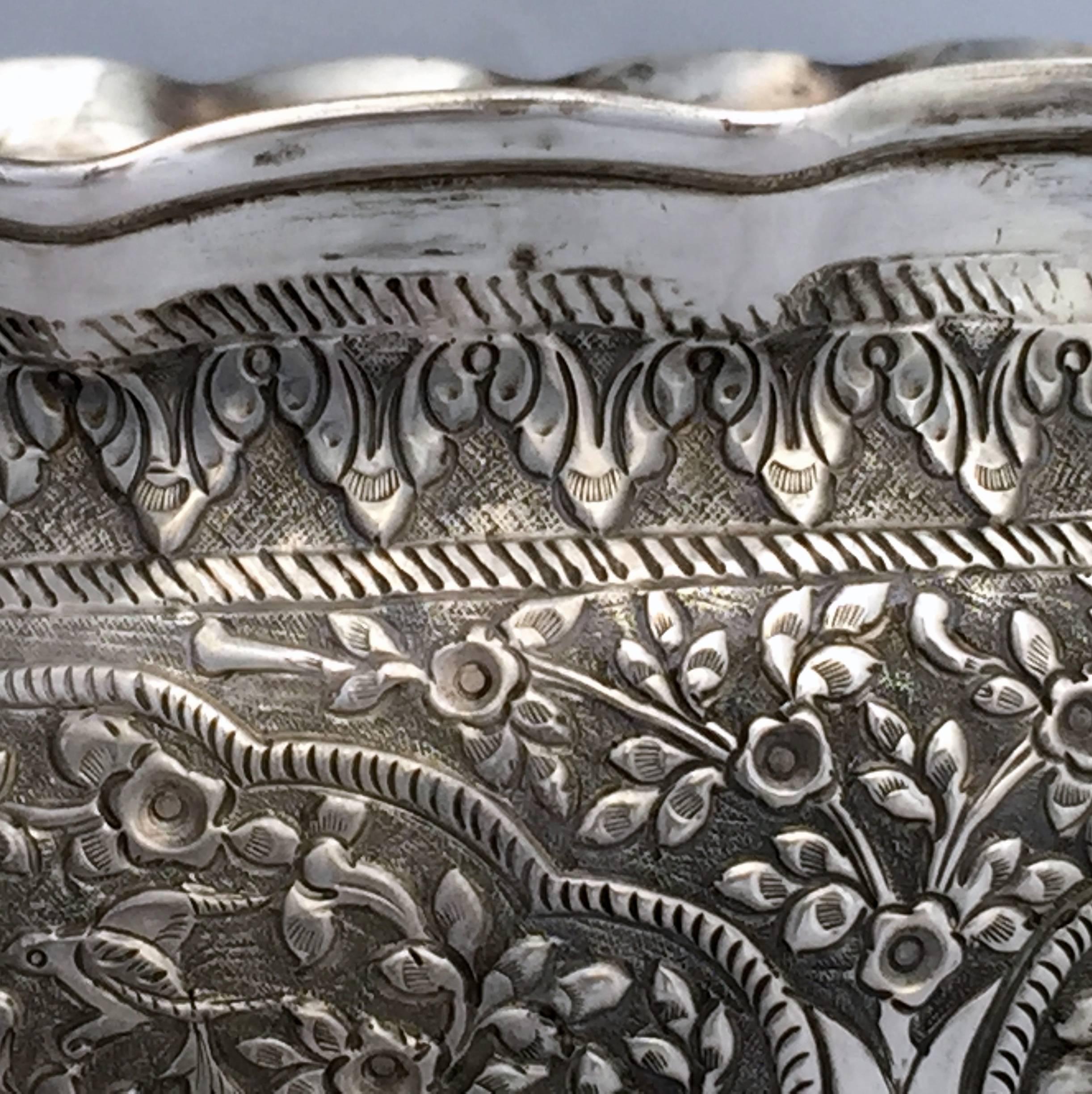 A huge Indian presentation bowl in the Cutch style, considered to be the best example of Indian silver craftsmanship in the late 19th century and much collected. 
The panels are worked with the infinite scrolling pattern that the Cutch craftsmen