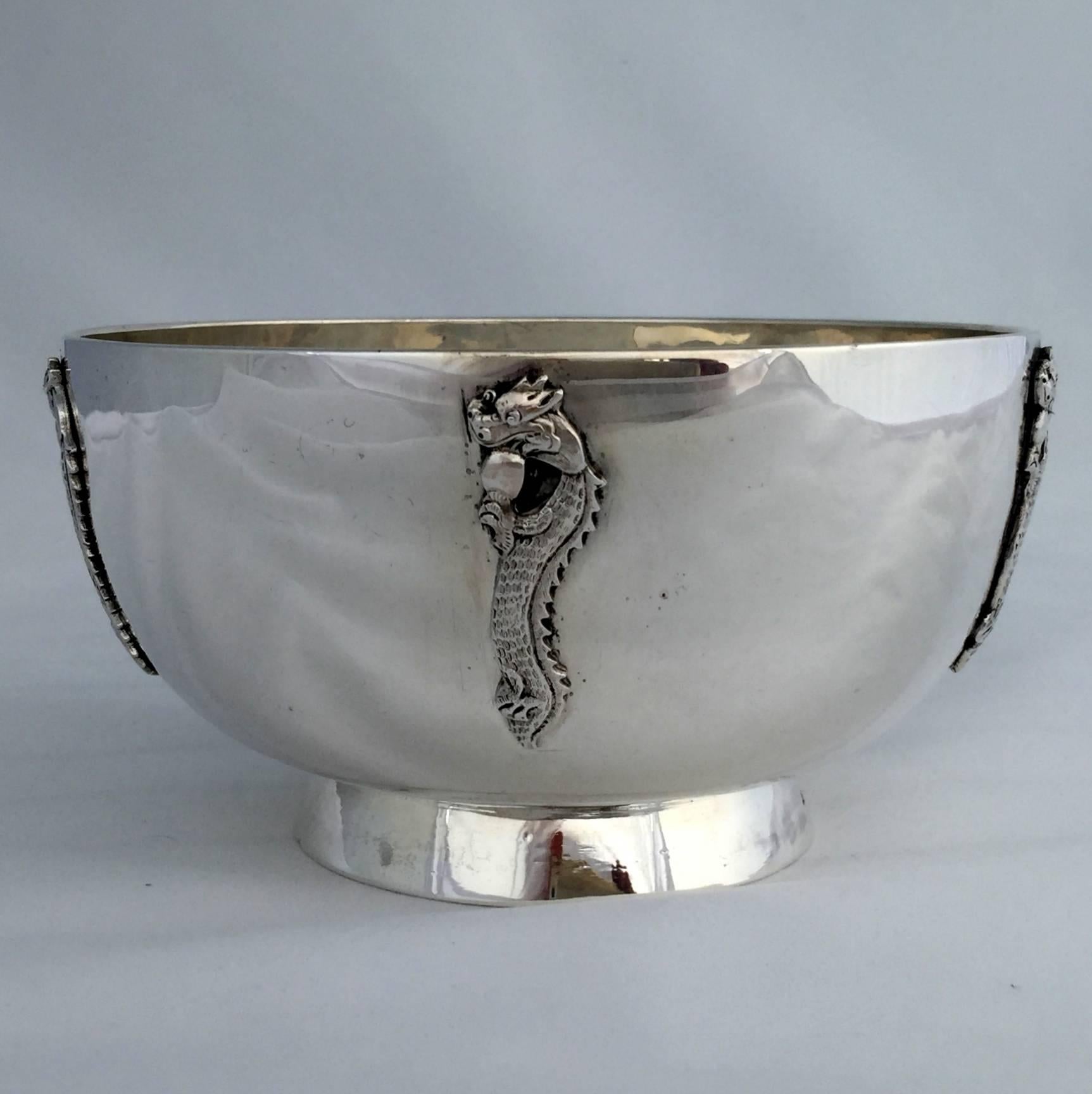 This is an exceptional Chinese export silver bowl, the silver content is 95%+ silver rather than the usual 92.5% silver that Wang Hing normally used. Five vertical dragons have been applied to the polished surface. Each one is four clawed and