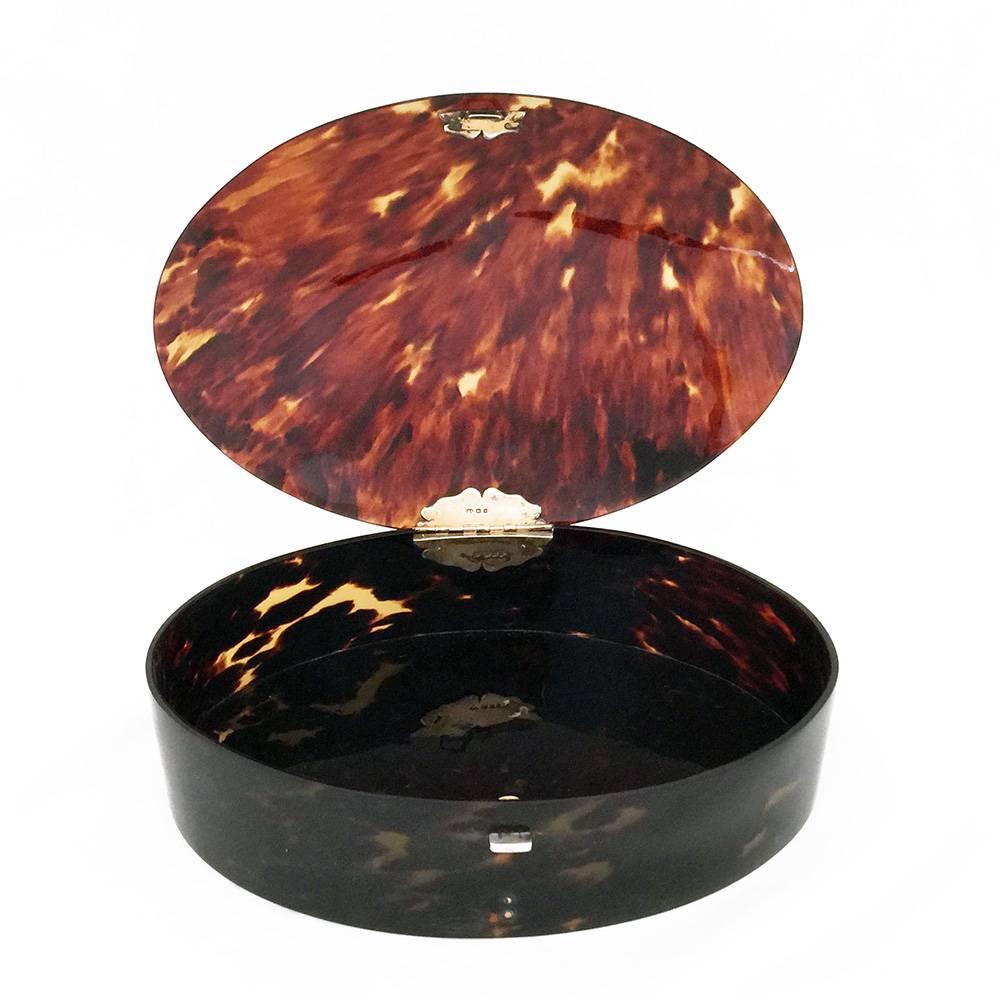 A large oval tortoiseshell box. The rounded lid and the curved sides all finely worked in excellent condition. The silver hinge is hall marked and so the box can be dated accurately to 1922.