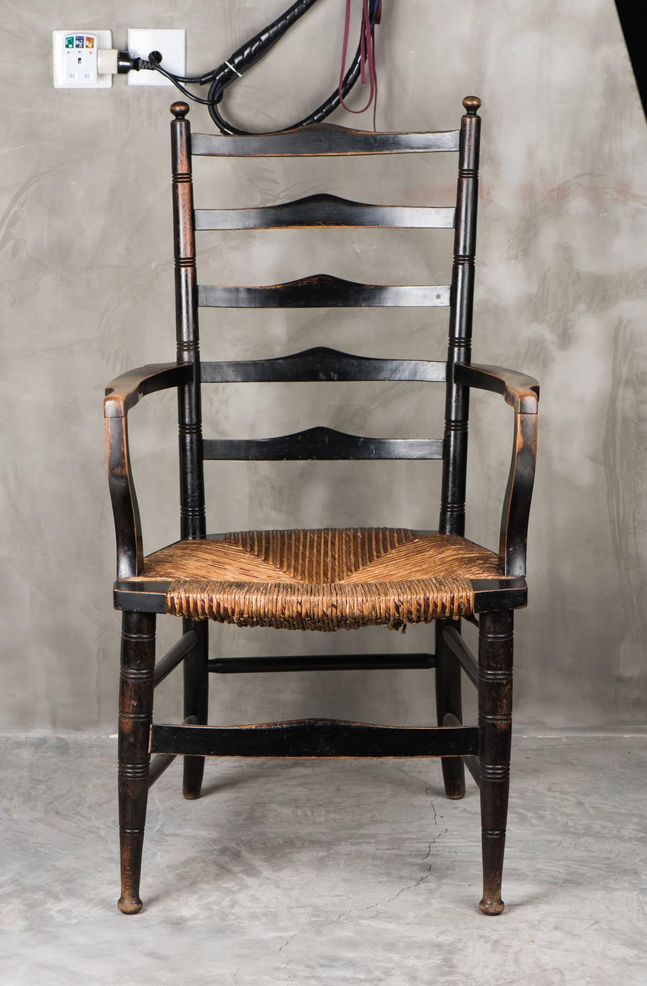 English Arts & Crafts ebonised beech wood ladder-back armchair, thought to be from Liberty & Co (London), circa 1890. Arthur Lasenby Liberty, in 1874, took out a GPB2000 loan from his future father-in-law to rent the first of a row of stores