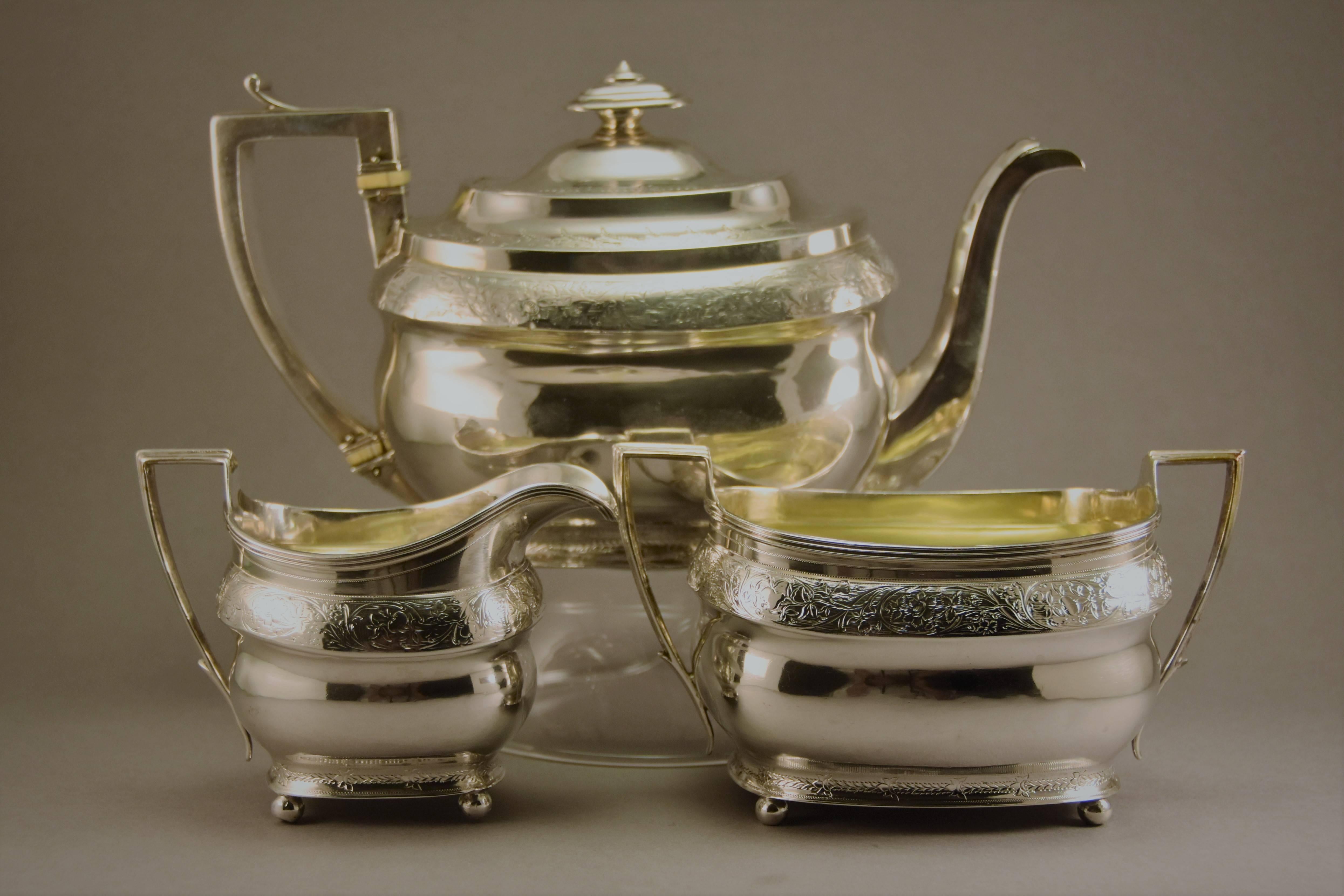 George III sterling silver tea set made in London by Napthali Hart hallmarked and dated 1805

Beautifully hand engraved with foliage and flowers. 
Oblong bellied form, scroll handles, the with insulators, a flush-hinged cover with a rectangular