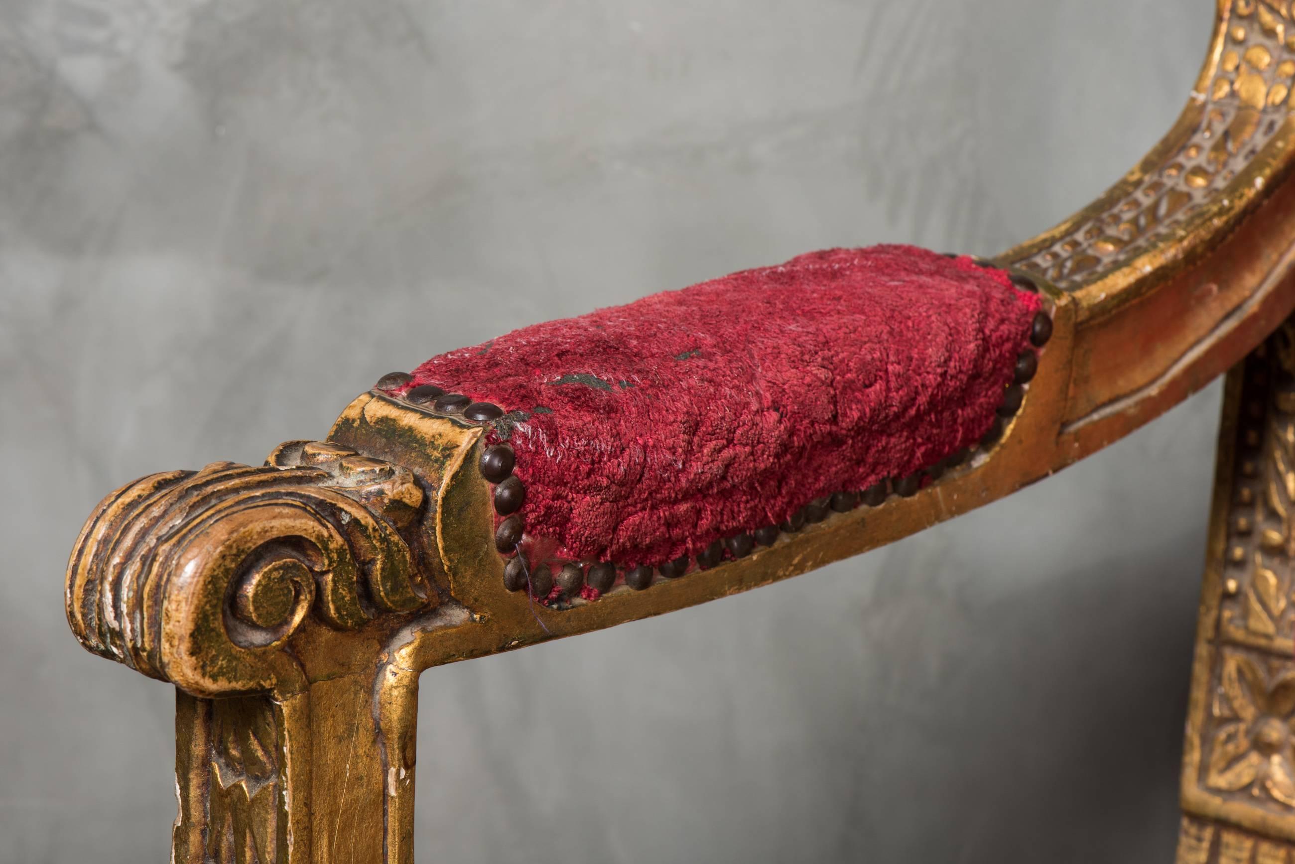 This dramatic pair of thrones, found in England, have a regal style with gold painted wooden frames, ornate carving and a floral vintage fabric. The wear and tear is consistent to both and offers an often desired shabby chic look. Perfect for an