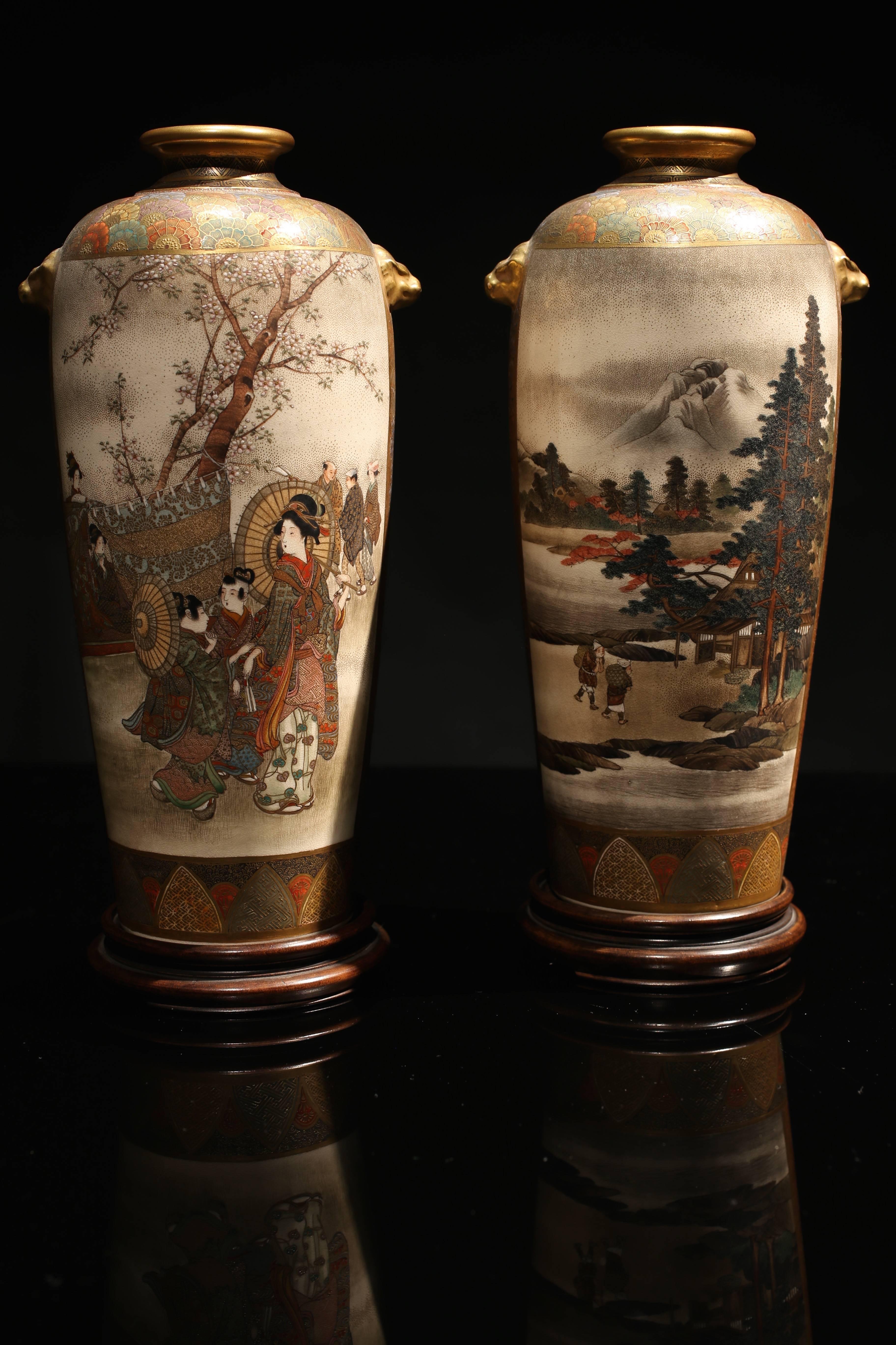 A superb quality pair of Japanese Meiji period Satsuma vases by Hozan.

In excellent condition and very finely painted with figures in a landscape scene and fine gilded highlights.

Together with their original turned stained beech bases and an