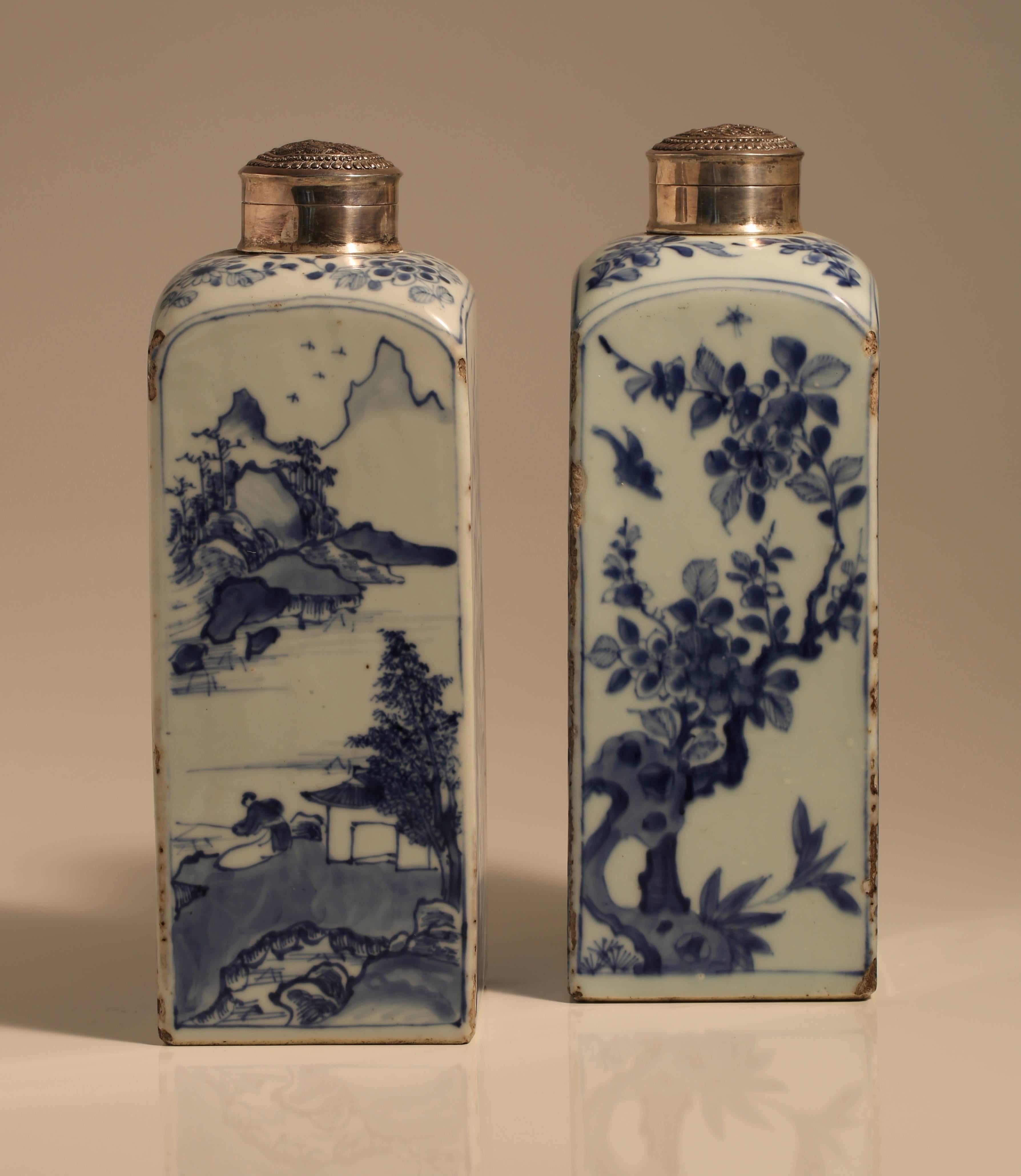 4285, fine pair of mid-17th century transitional Chinese blue and white porcelain gin bottles with later silver lids. Each face alternately decorated with figures in a landscape and then birds and insects in foliage. The bases unglazed, minor chips