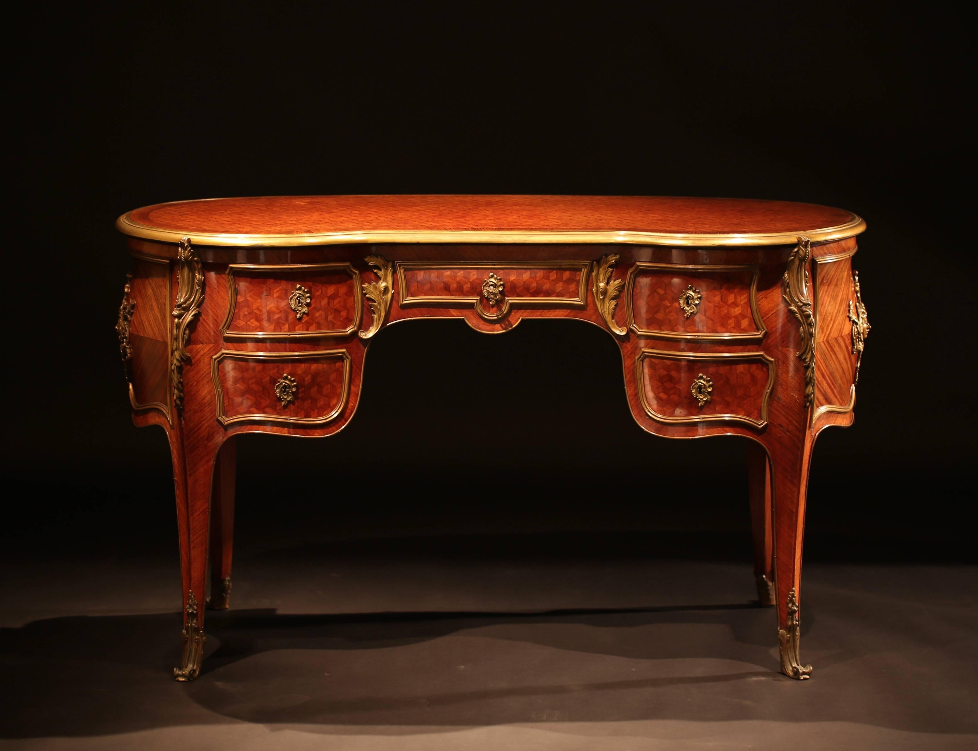 A good quality 19th century French Louis XV style parquetry and ormolu-mounted bureau plat of kidney and bombe shape, with five drawers. Very good condition, good quality mounts and relatively scarce shape. Stamped by J.A.S Shoolbred & Co (An