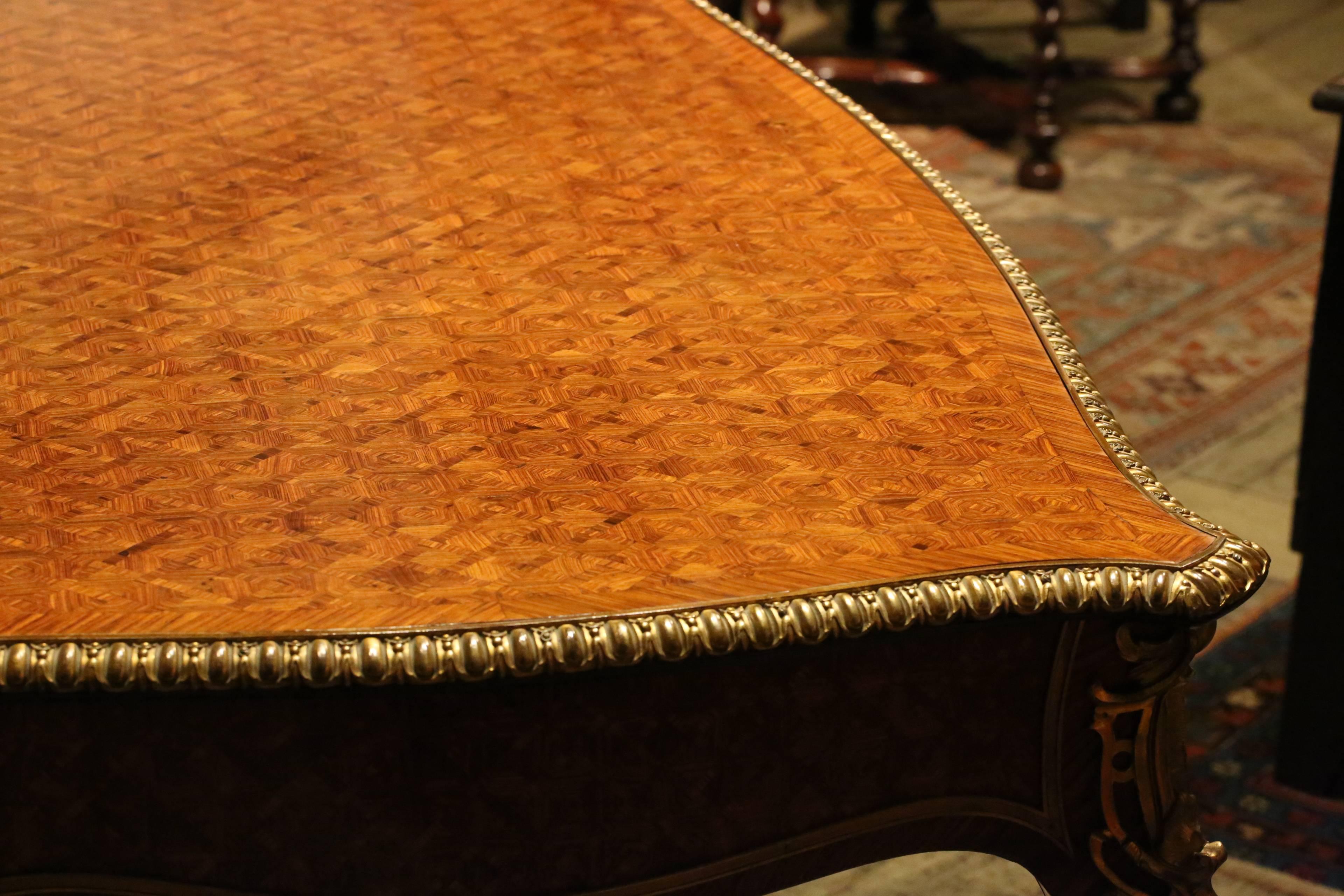 A very fine quality, 19th century parquetry, kingwood and ormolu-mounted bureau plat in the Louis XV style. With a pair of drawers to one side, excellent quality mounts and gilding and of very handsome design. With an old label beneath