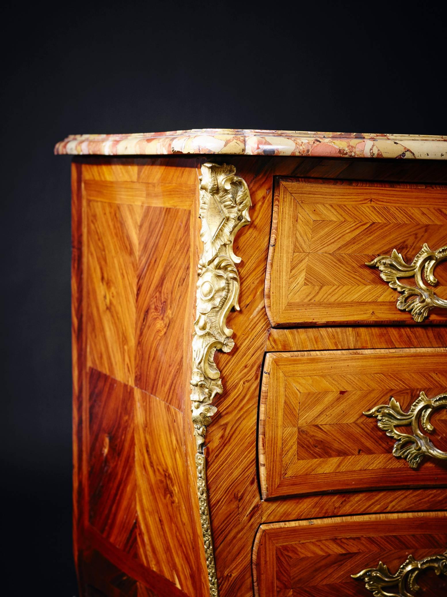 A fine Louis XV period tulipwood and kingwood marquetry and ormolu mounted commode by Antoine Criaerd, brother of the better known ébéniste Mathieu Criaerd. Having the original hand cut moulded edged and serpentine shaped Breche D’Alep marble top