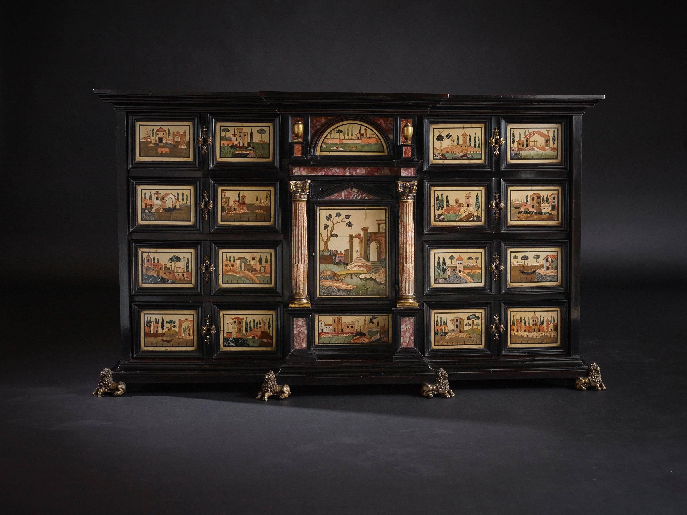 An early 17th century Florentine pietra dura inlaid cabinet.

Of architectural breakfront form, with a layered moulded cornice above the main body of the cabinet. The façade inspired by the form of a palazzo, with a central portico design having