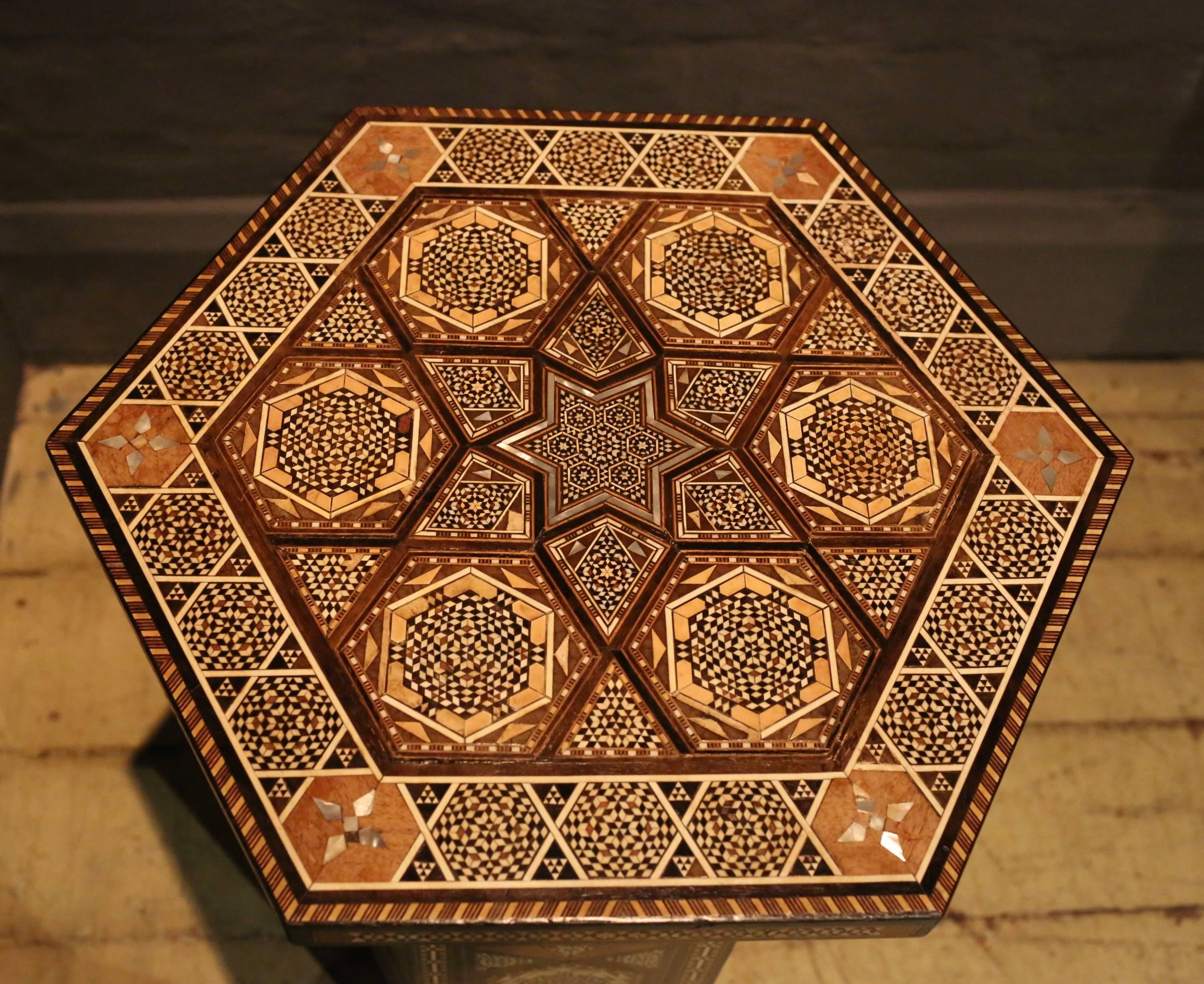 A very fine quality early 20th century Syrian parquetry inlaid hexagonal occasional table. Veneered all over in a micromosaic type geometric parquetry design in specimen wood, bone and mother of pearl. With a hidden 