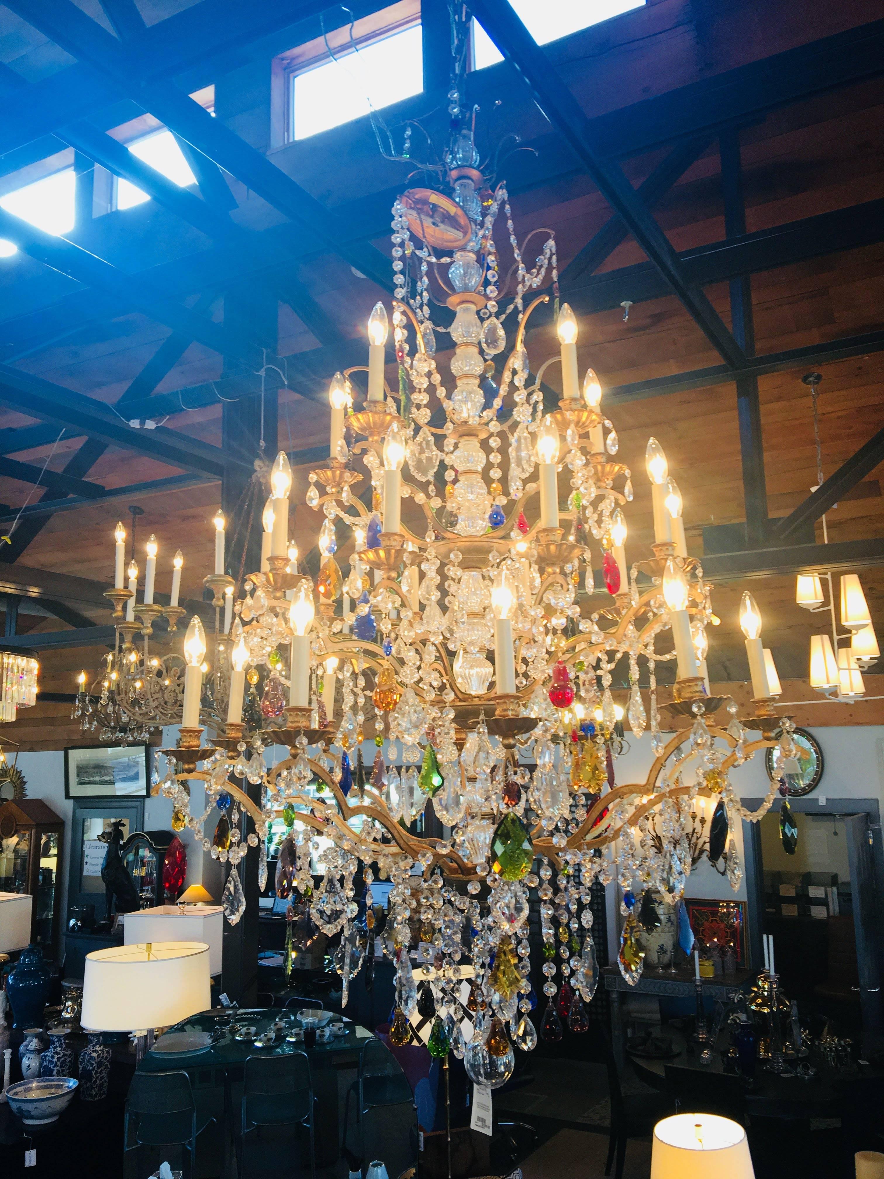 Louis XIV style multicolored crystal chandelier by Schonbek
Measure: 64.5 inches high x 40 inches wide
Chain 126 inches. Retails at $12,000.