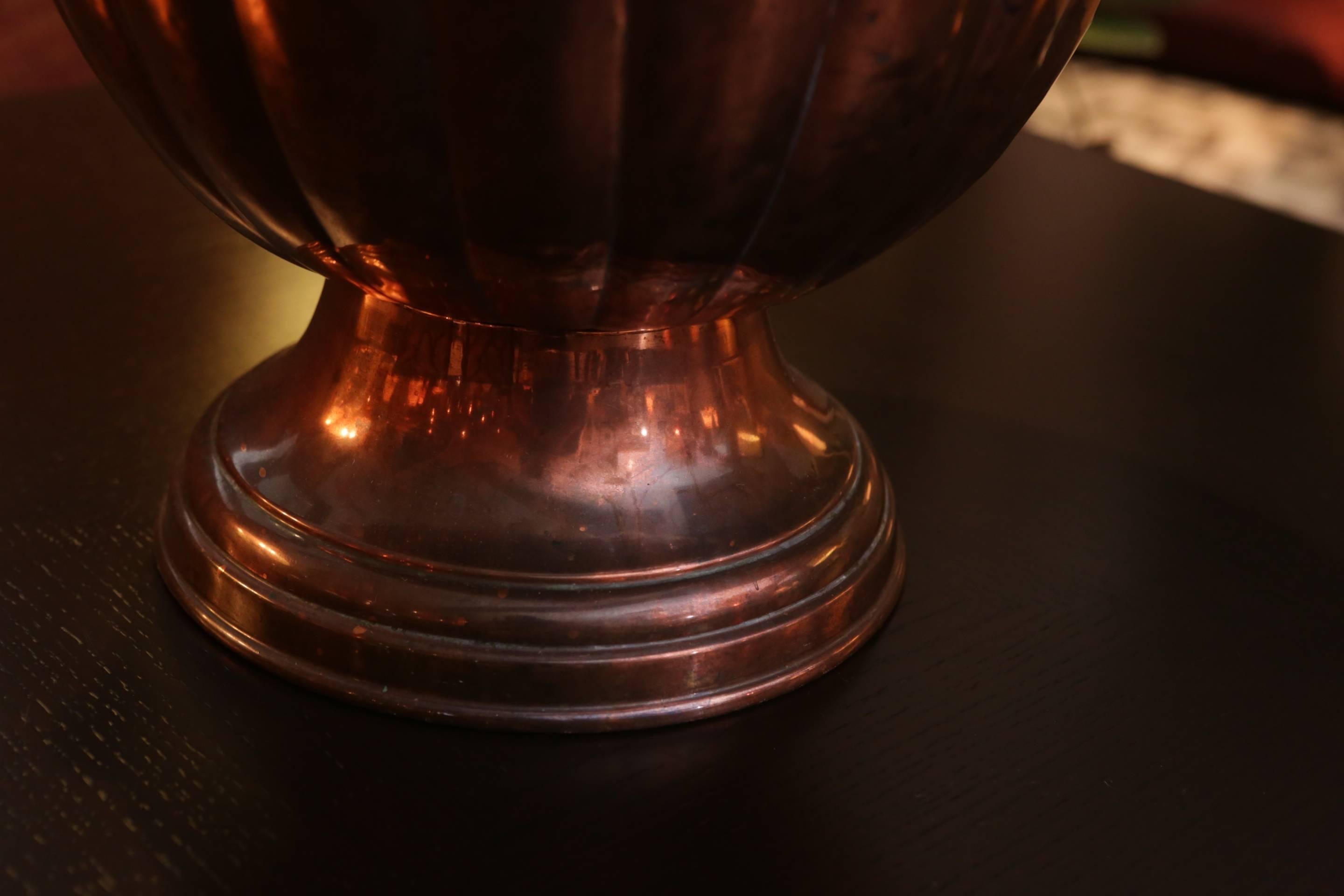 19th century copper coal bin with lid. Fluted-shaped acorn top with braided iron handle. Would work fabulously as a wine cooler or simply as an objet d'art.