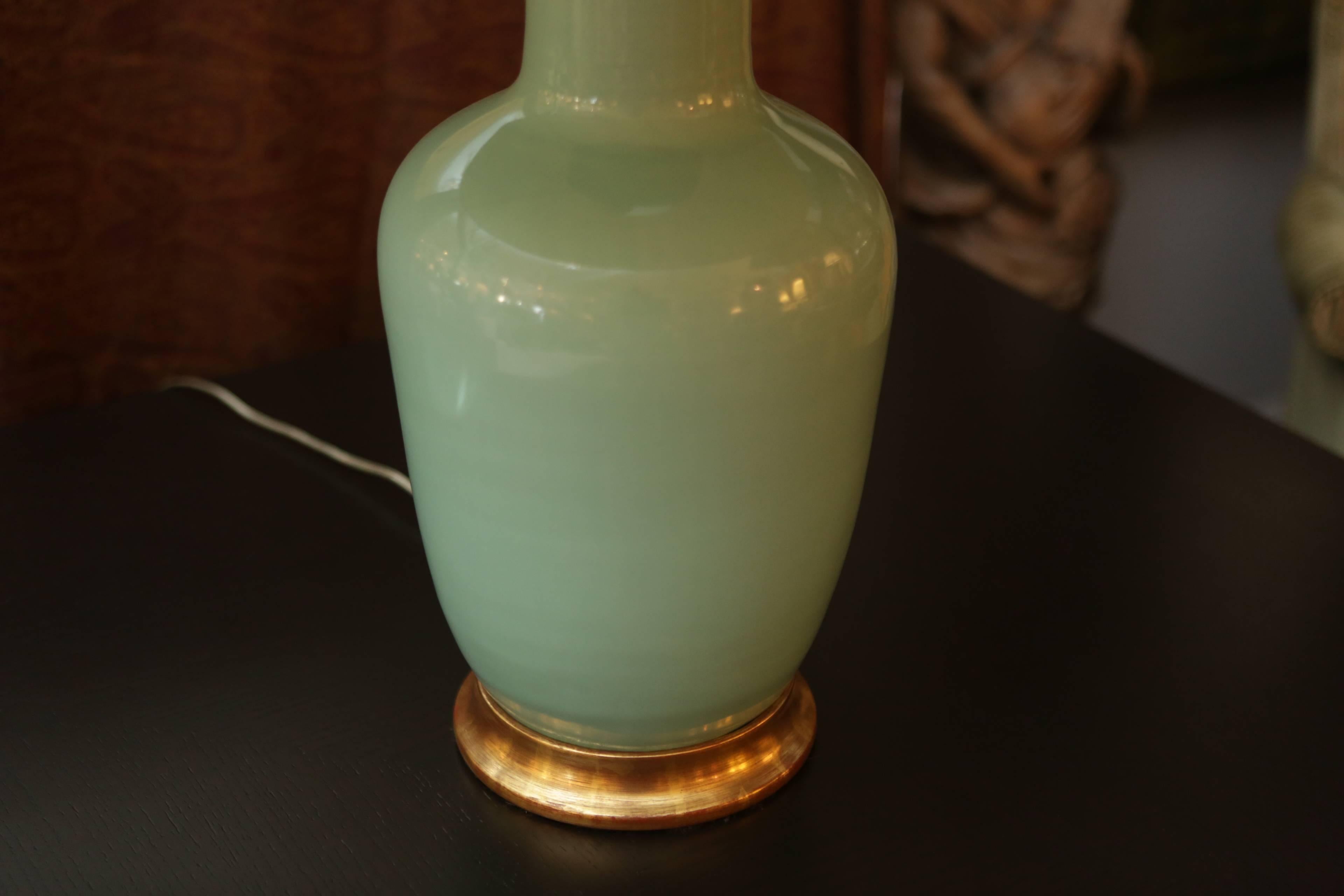 A beautiful Christopher Spitzmiller celadon colored ceramic ginger jar style lamp. The base is finished in 24-karat gold leaf.

Measurements: 30