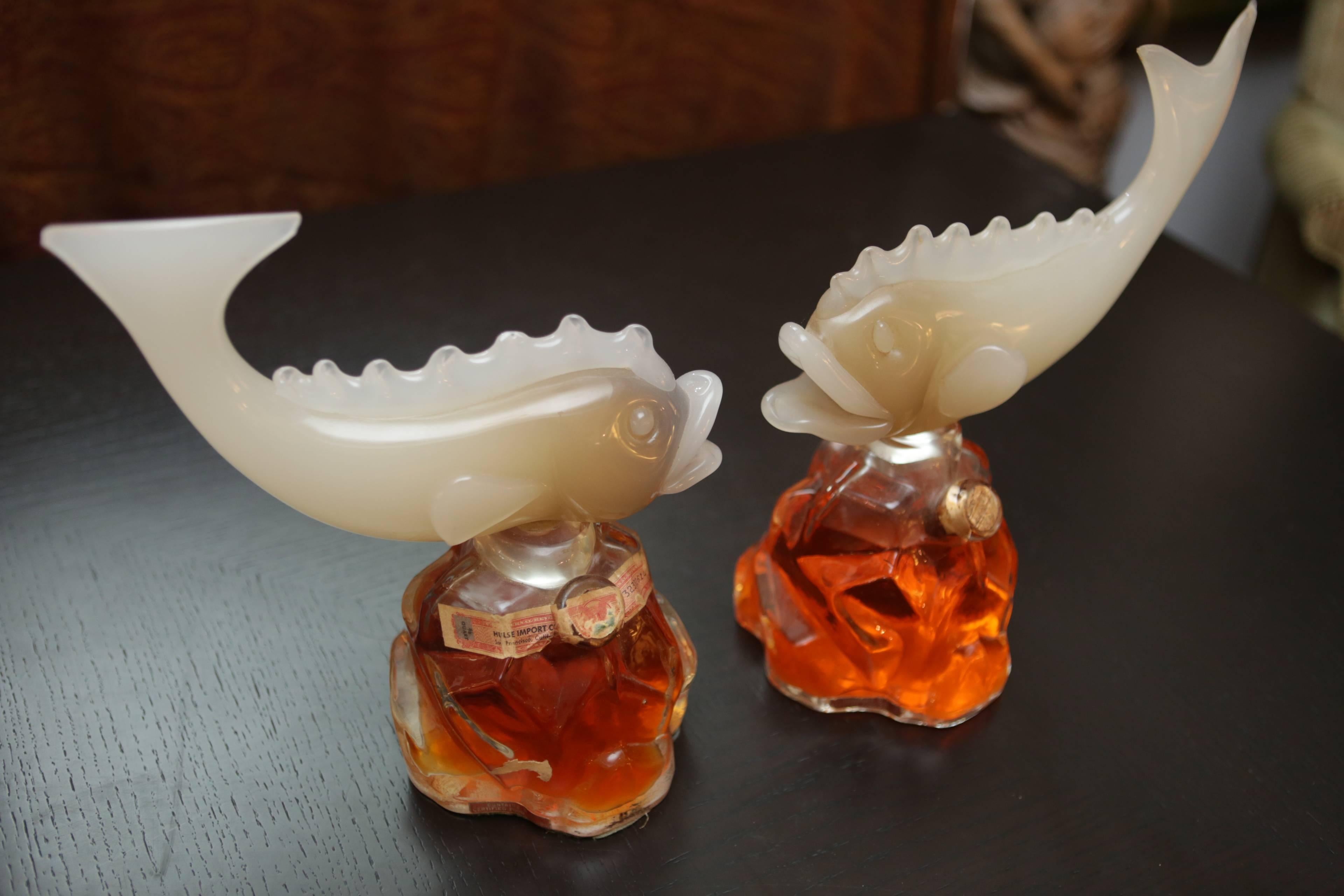 An unusual pair of Murano glass Italian fish decanters from the 1920s. Has original customs sticker over one of the corks from San Francisco. Contains orange-colored liquid, most likely a brandy or liqueur.

Both fish are uniquely handmade, each