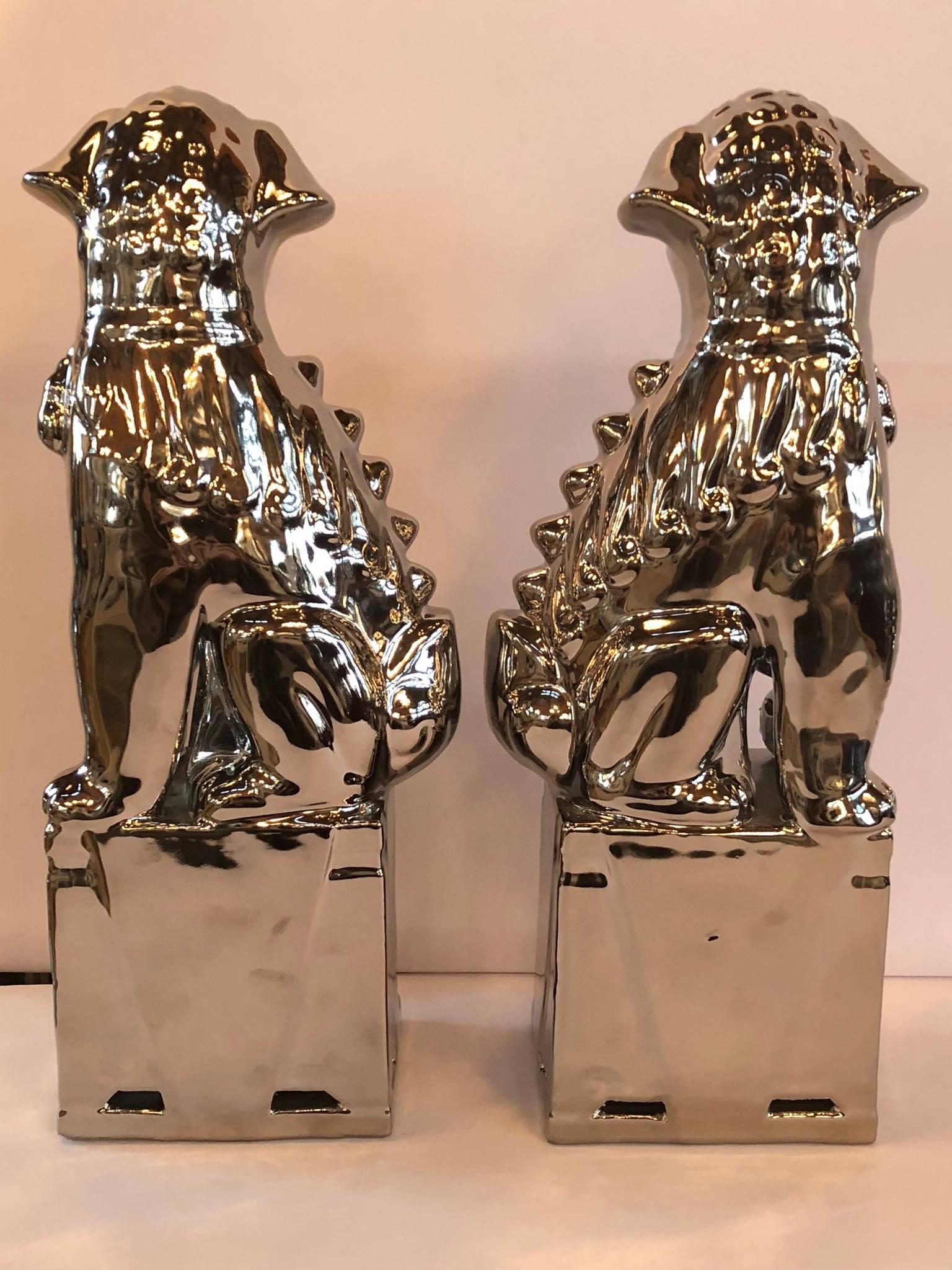 Pair of large silver foo dogs. Measures: 4.75