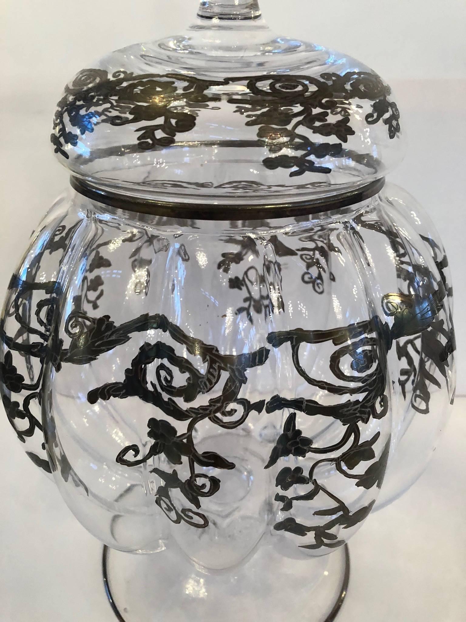 Pair of antique glass jars with silver etching and removable lids.