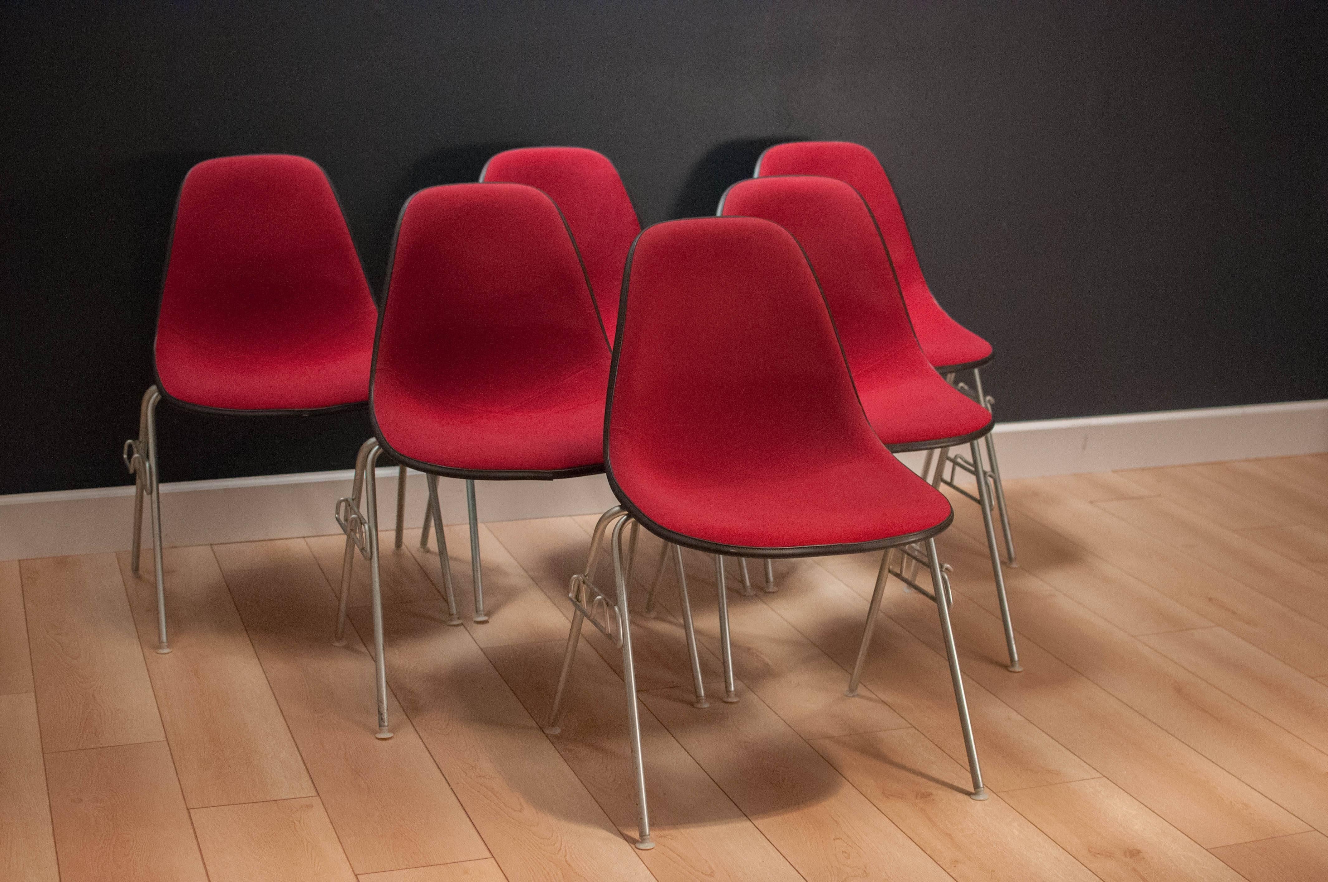 Mid-Century Herman Miller stacking chairs designed by Charles and Ray Eames, circa 1978. These black fiberglass shell chairs have the original Alexander Girard fabric in great condition. 

 