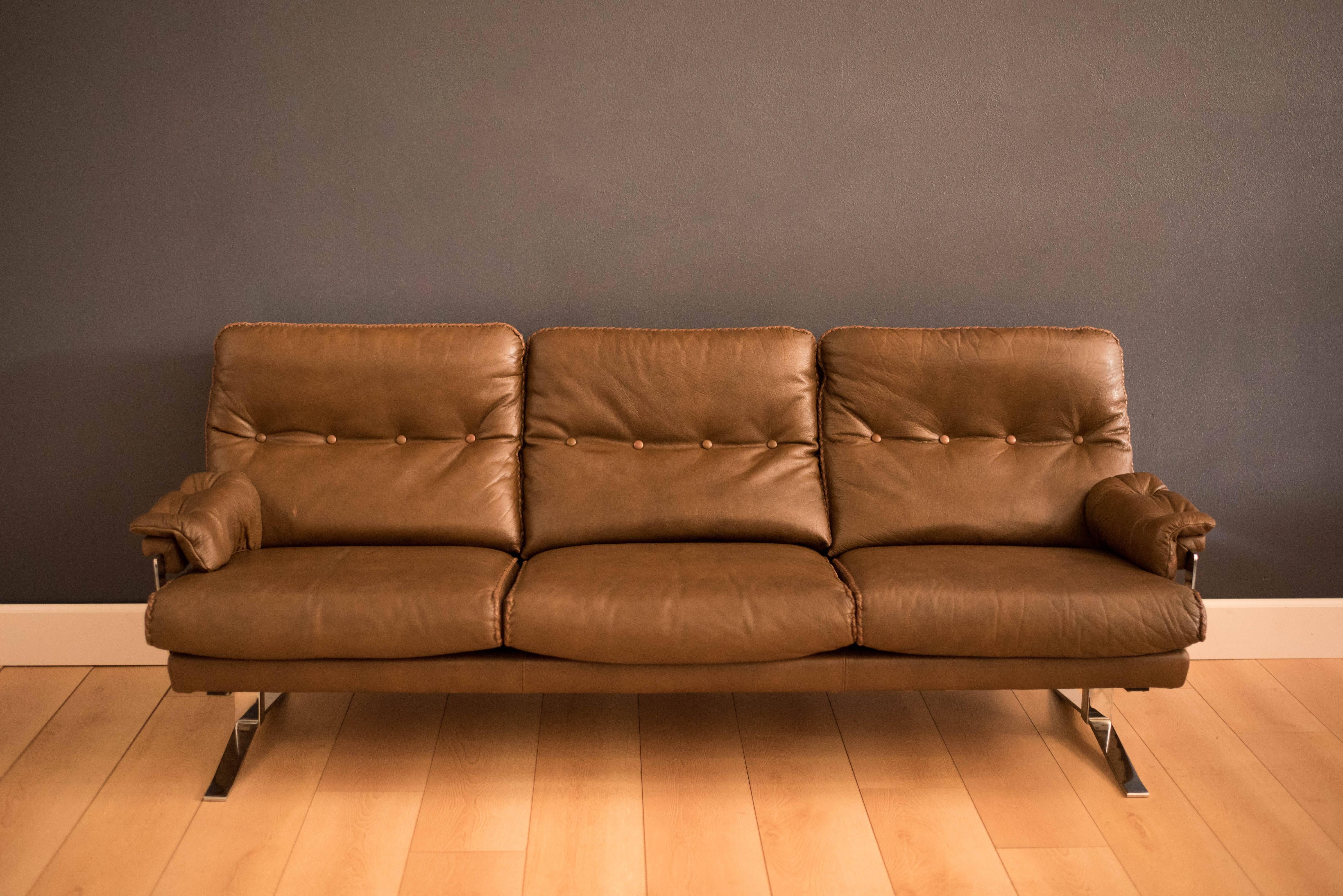 Mid-Century leather sofa for by Arne Norell for Vatne Mobler. This three-seat sofa features a unique chrome base and hand-stitched leather seams. 

 