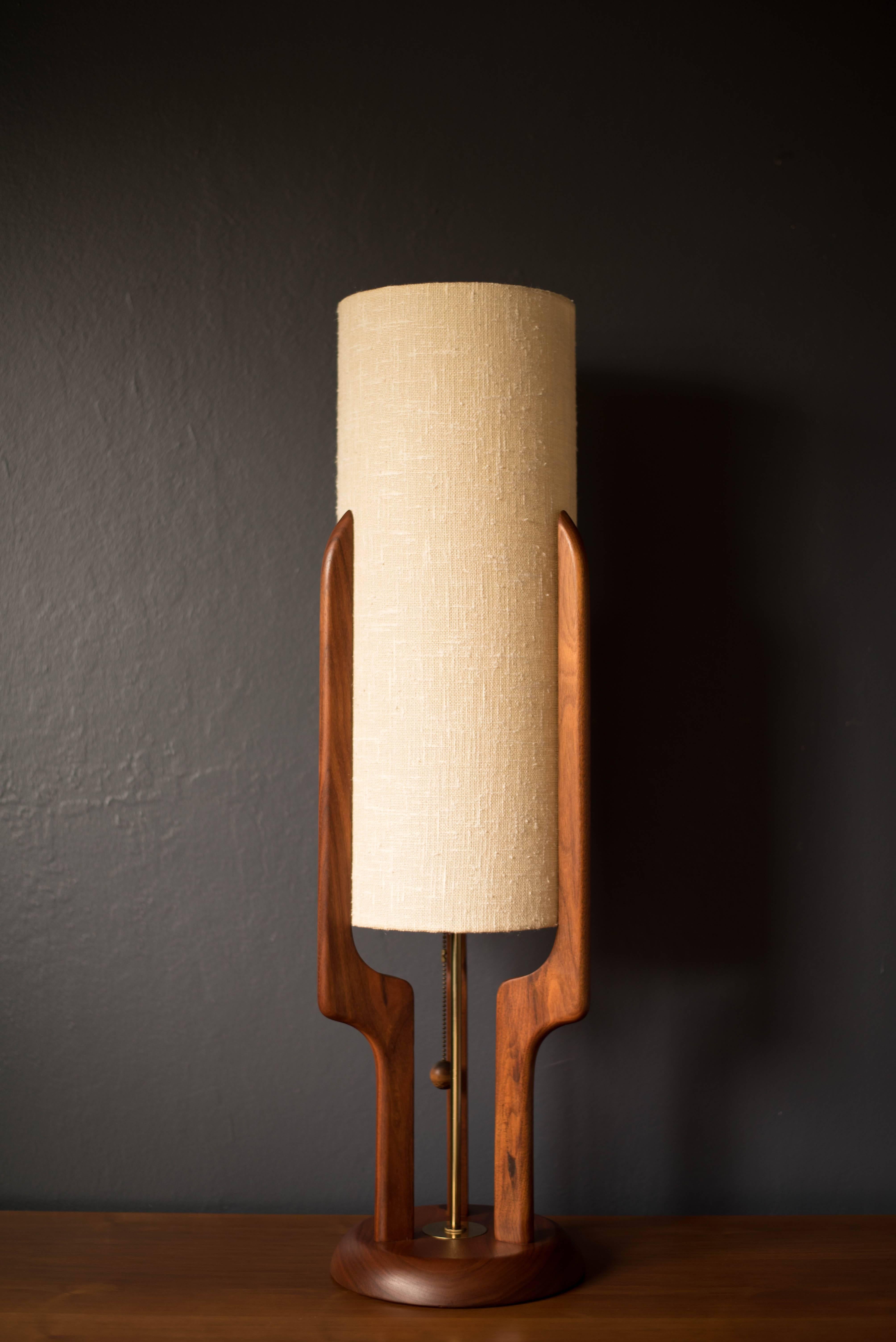 Mid-Century Modern sculpted walnut lamp, circa 1960s. This piece features a stunning walnut base and includes the original shade.

