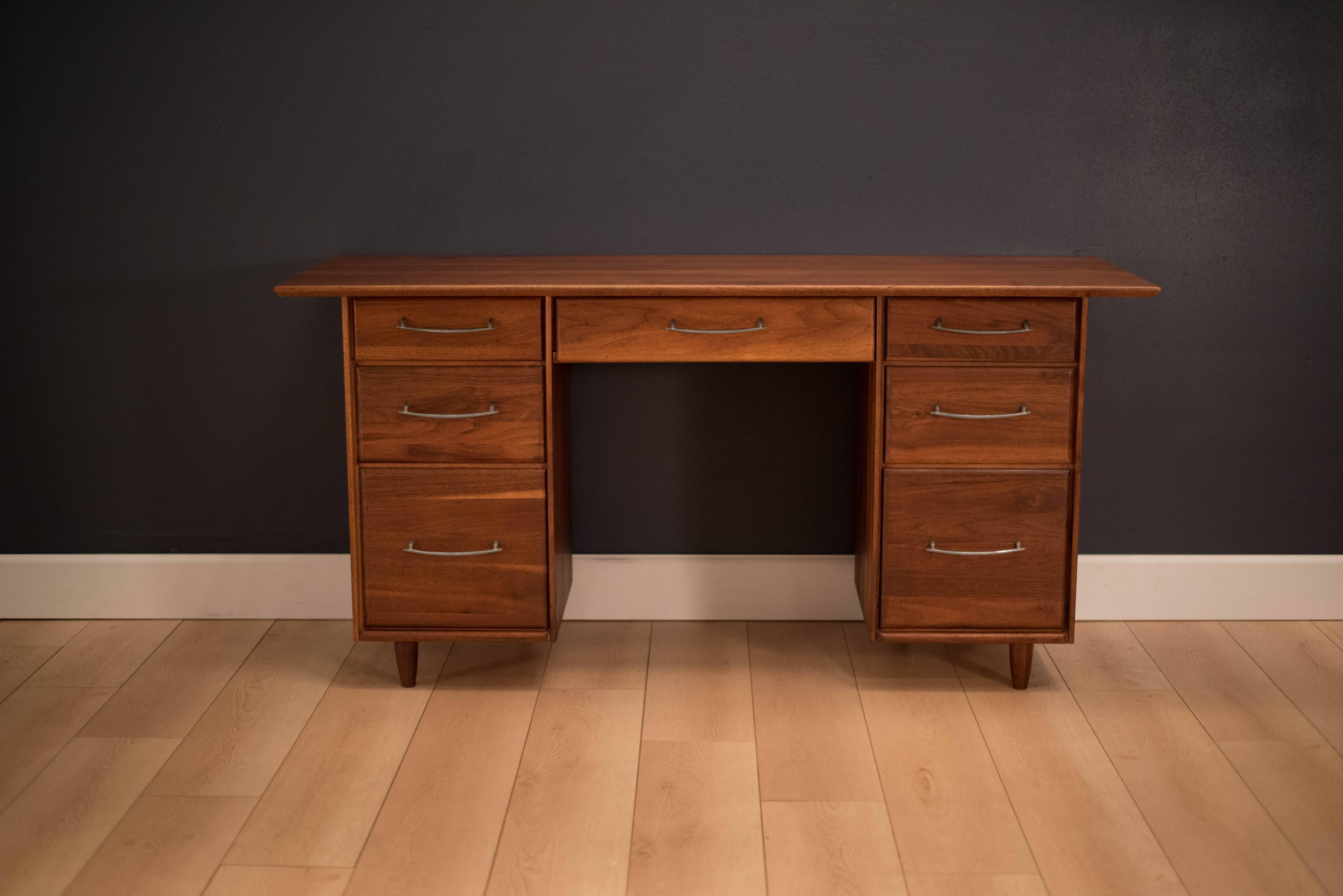 Mid-Century Modern ACE-HI desk in solid walnut. This desk offers plenty of storage space complete with seven spacious drawers accessorized with pewter handles.

 