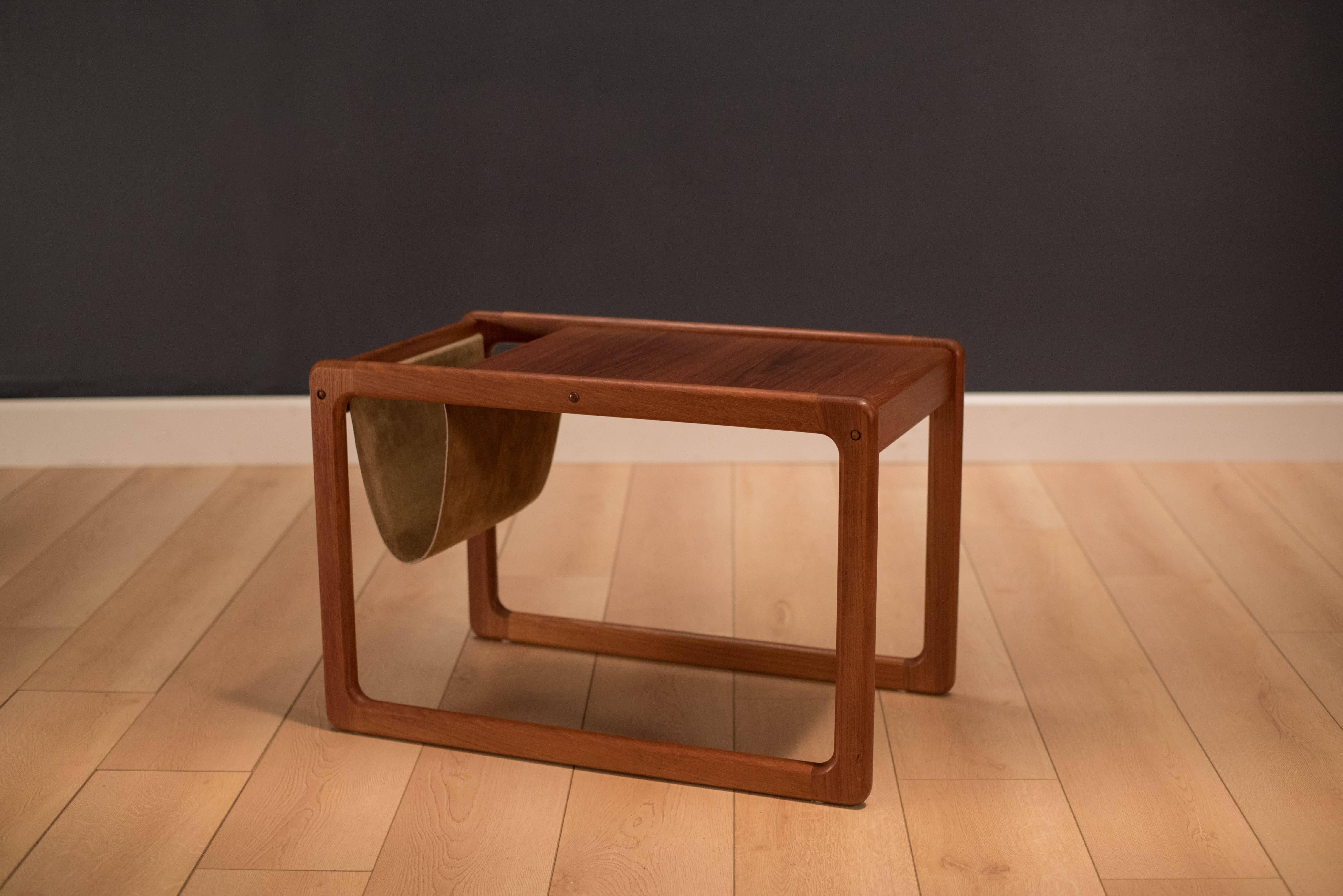 Danish leather magazine rack with attached end table. This unique piece is made of teak with a sculpted leg base. 

