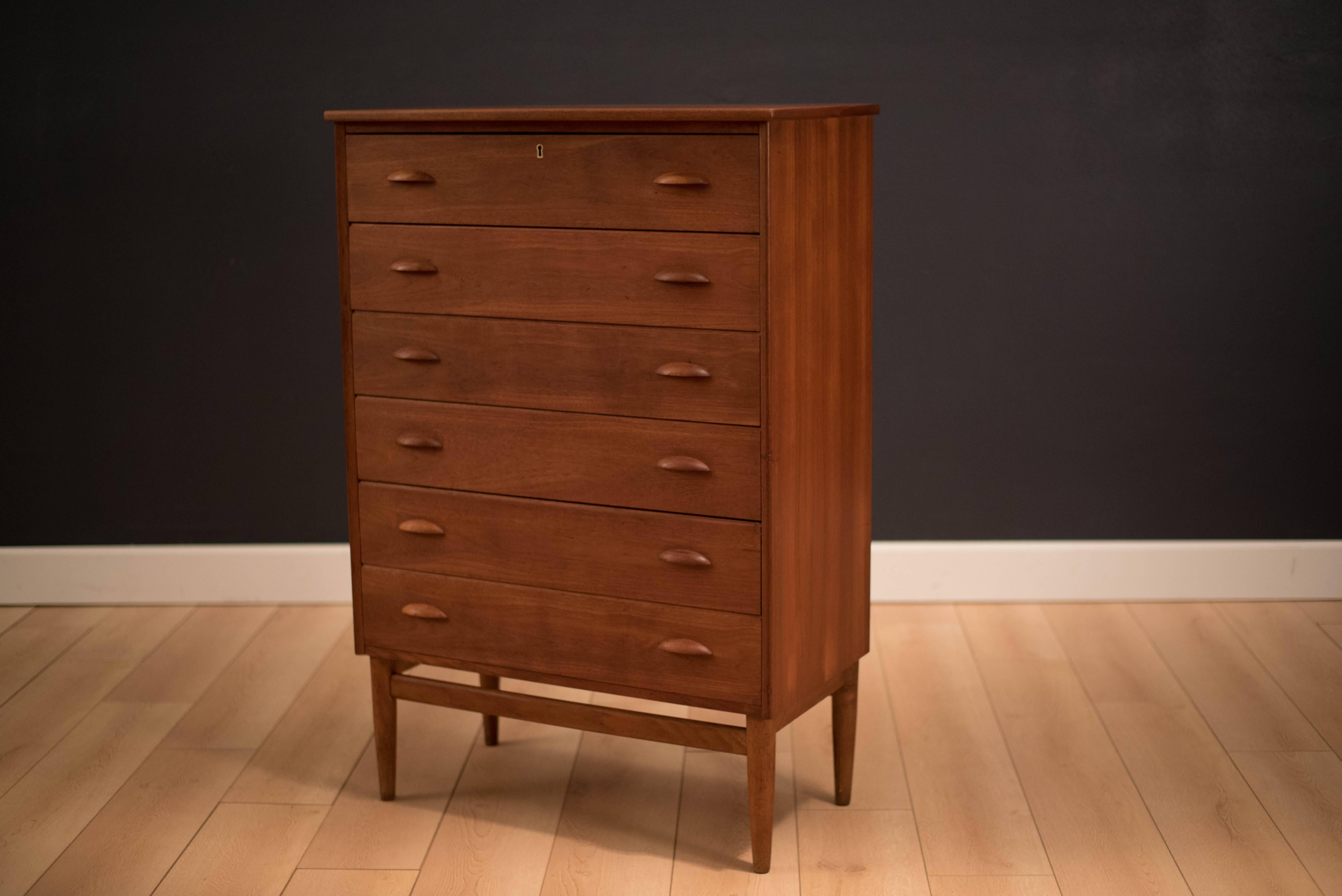 Danish modern tall chest in teak. This piece comes with six dovetailed drawers and a unique bowed top. Skeleton key included.
 
      