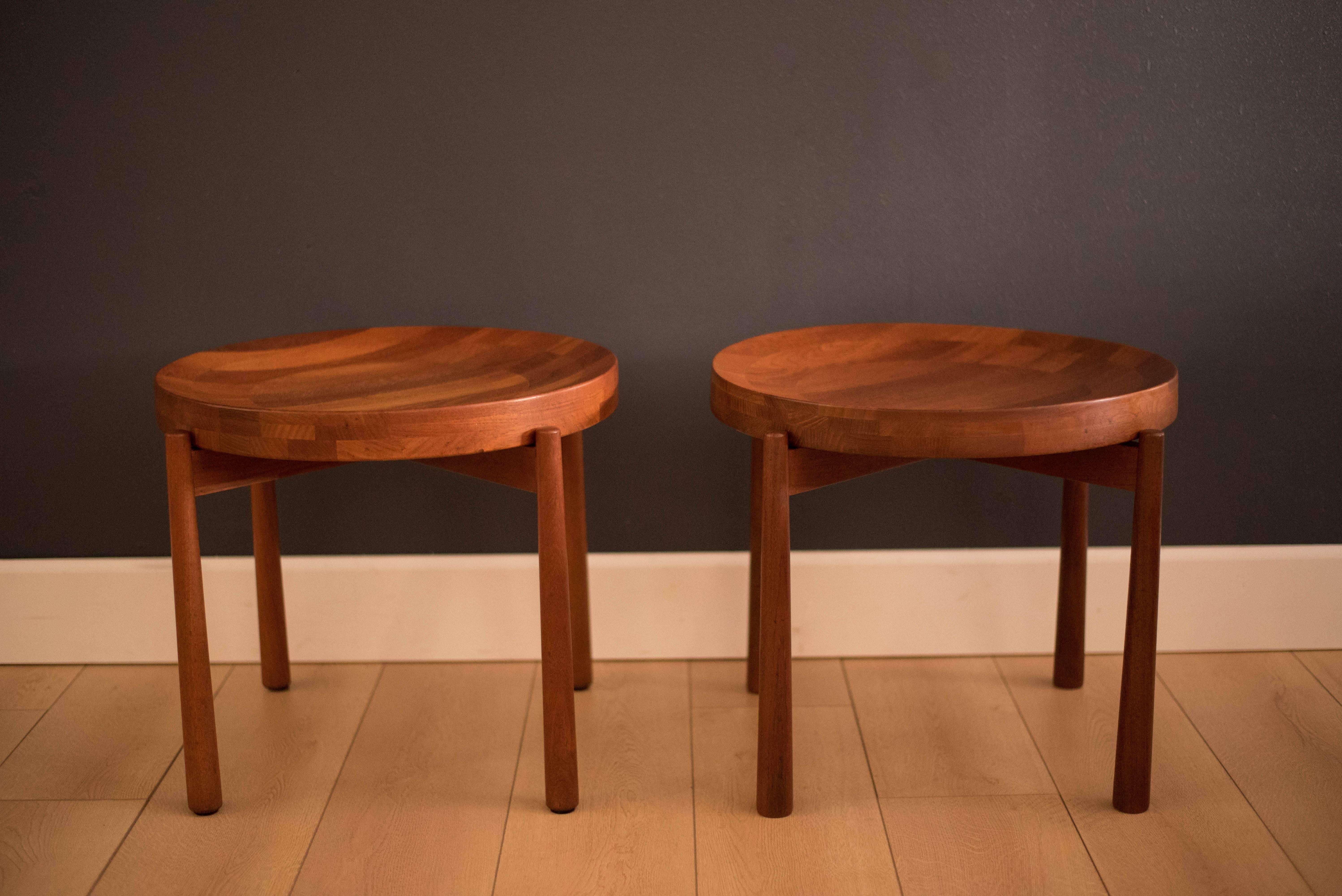 Mid-Century pair of staved side tables for Dux in solid teak. The tabletop is removable and rests on a sculpted teak base. 

