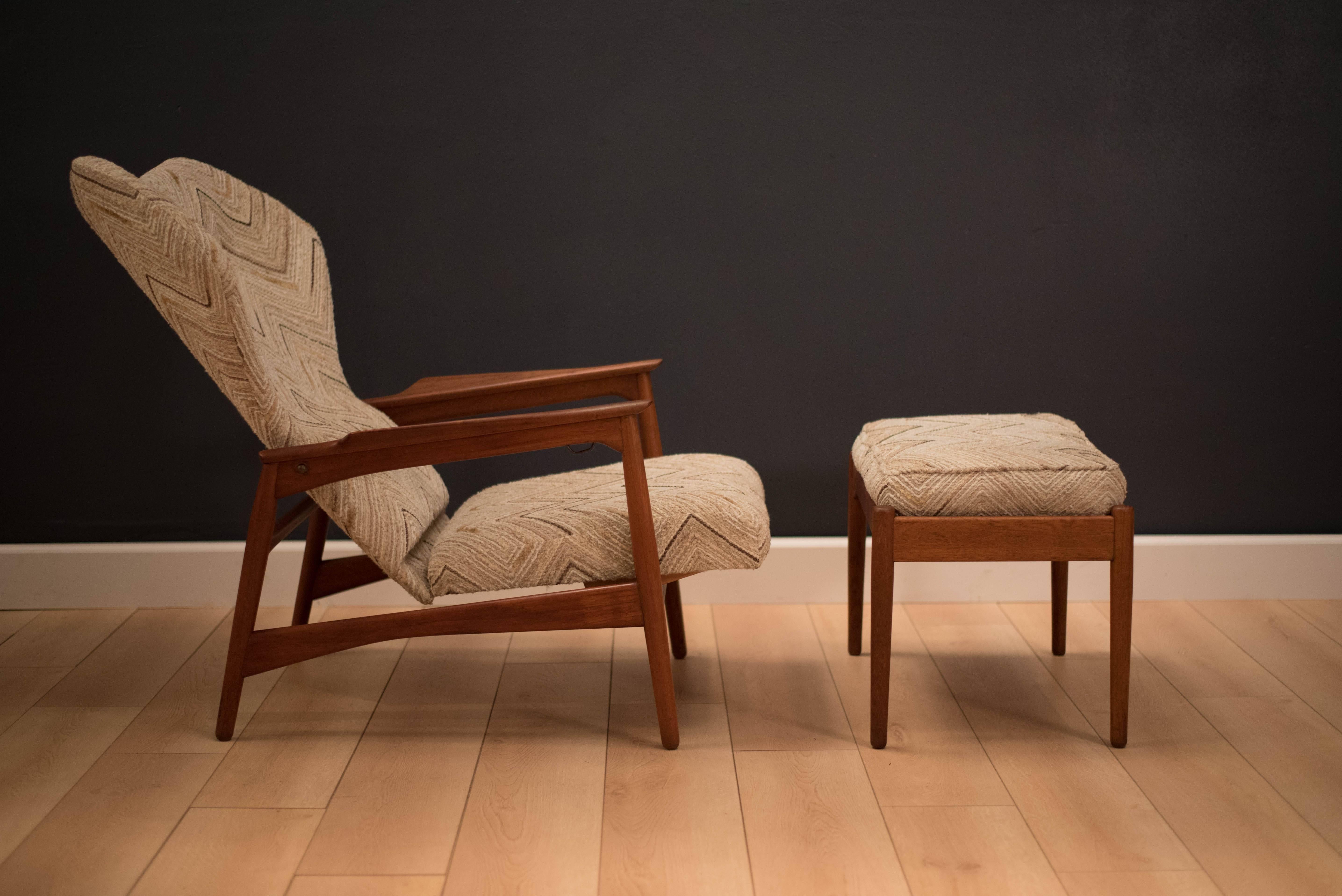 Mid-Century lounge chair by Ib Kofod-Larsen for Carlo Garhn in teak. This piece features a sculpted teak base that reclines by tilting back. Features a unique curved head rest and fabric is original to the piece. 

Lounge chair: 36" D fully