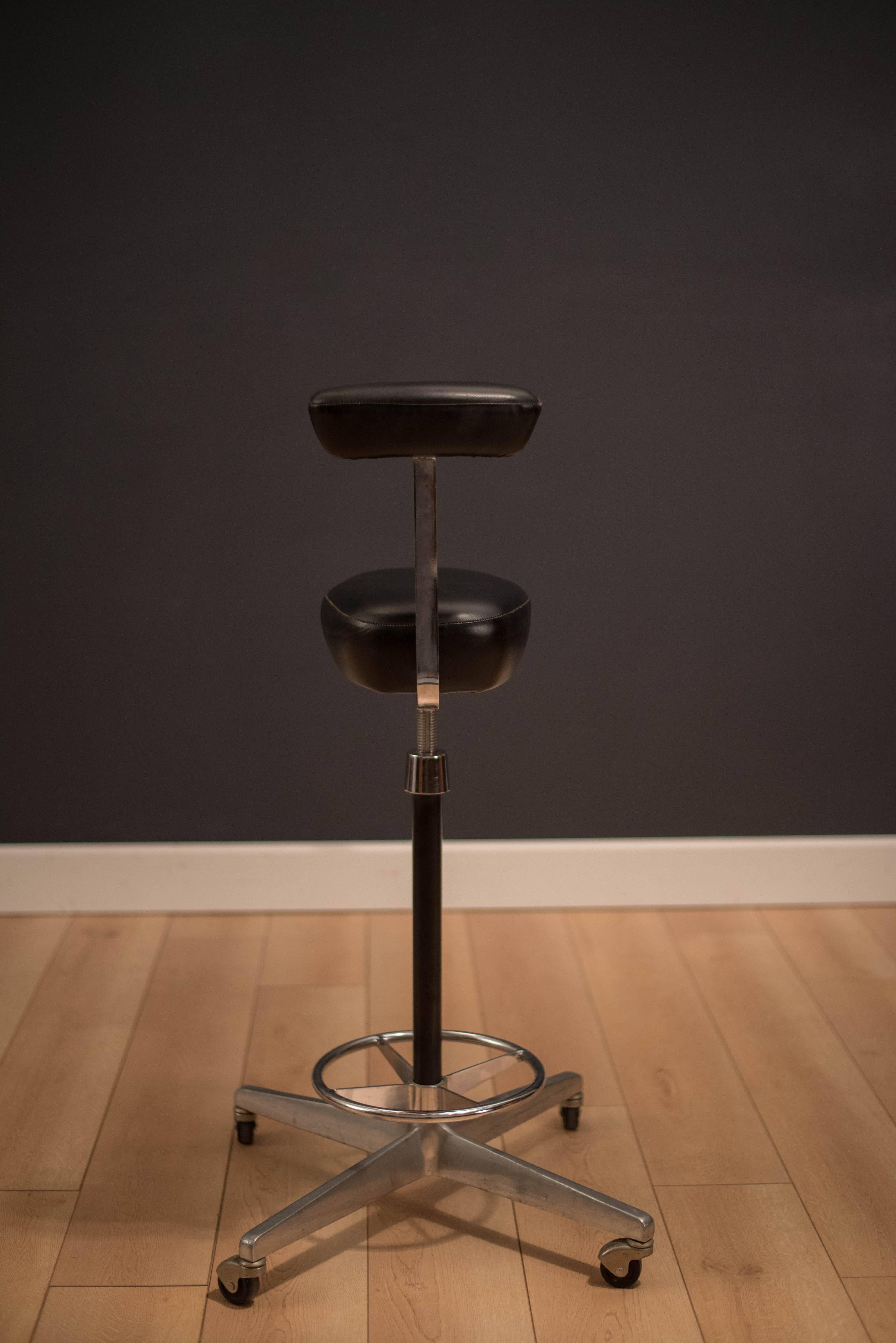 Mid-Century drafting stool by George Nelson and Robert Propst for Herman Miller. This piece sits on a heavy aluminum swivel base supported by casters. Black leather cushions are original.

Base: 21
