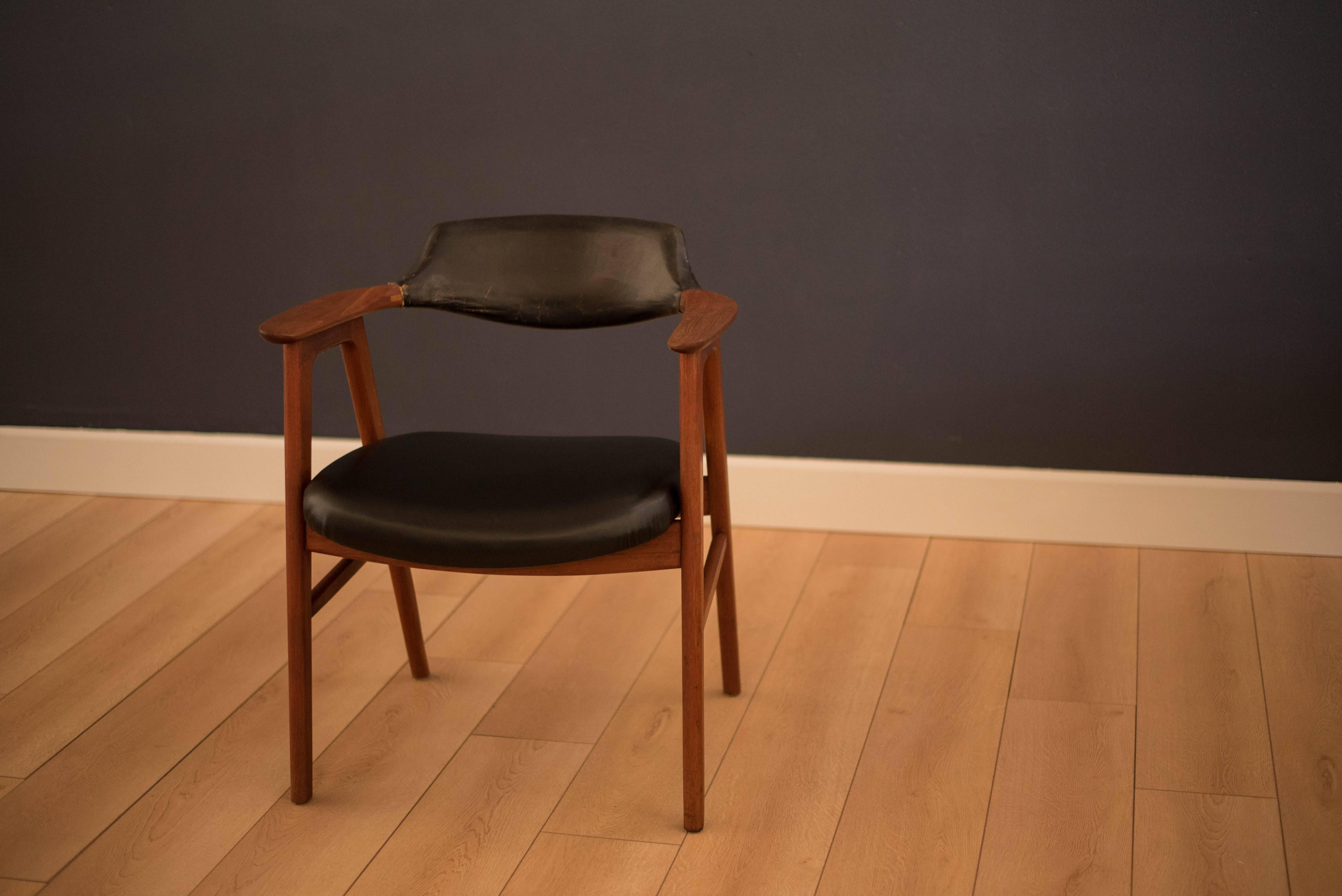 Danish modern armchair by Erik Kirkegaard in teak. This piece features a curved backrest with beautifully aged leather. Constructed of solid teak and displays quality craftsmanship.
  