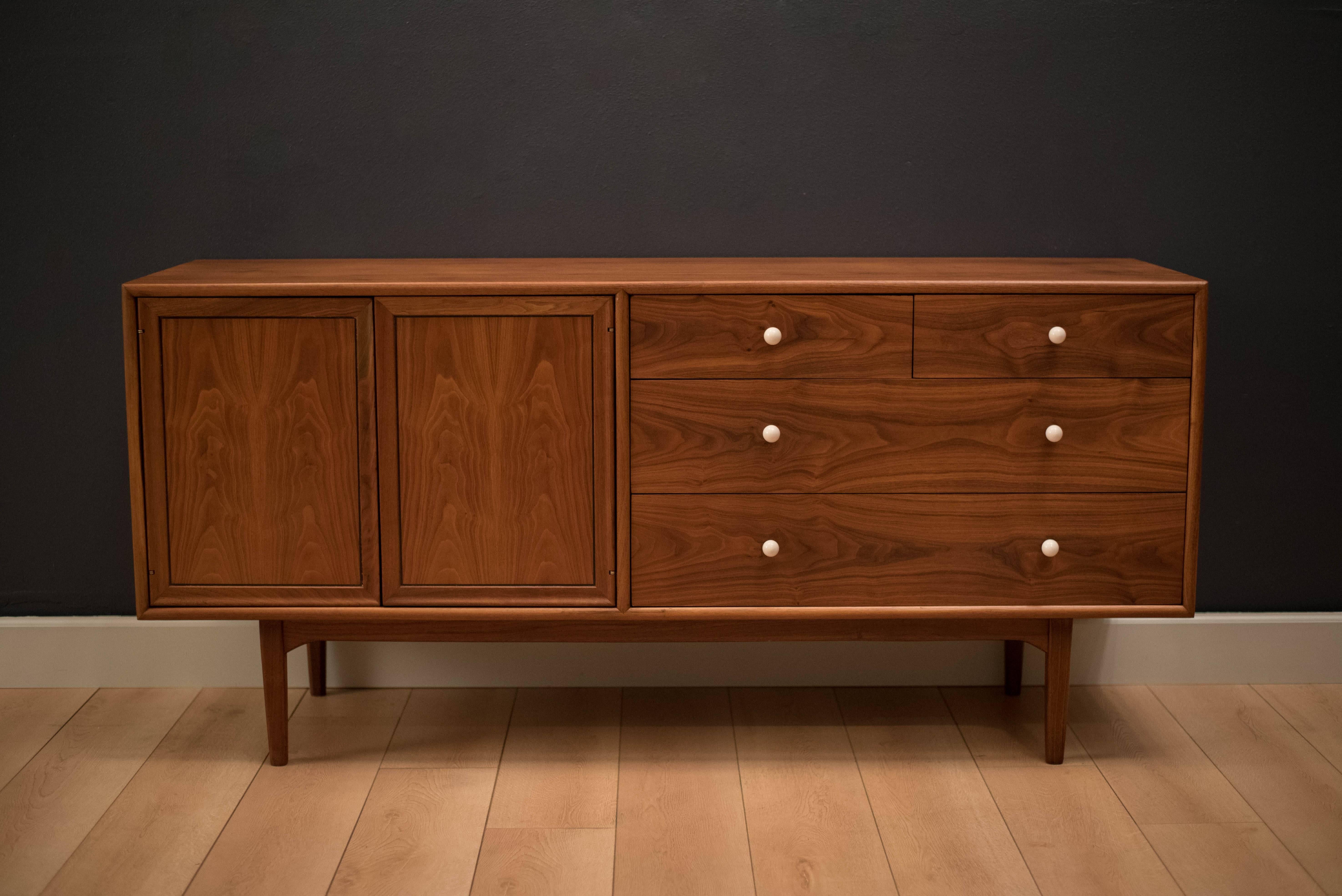 Mid-Century Drexel Declaration dresser by Kipp Stewart and Stewart McDougall. This piece is equipped with ten drawers accessorized with the signature white porcelain pulls. Case piece is bookmatched with black walnut grains.

  