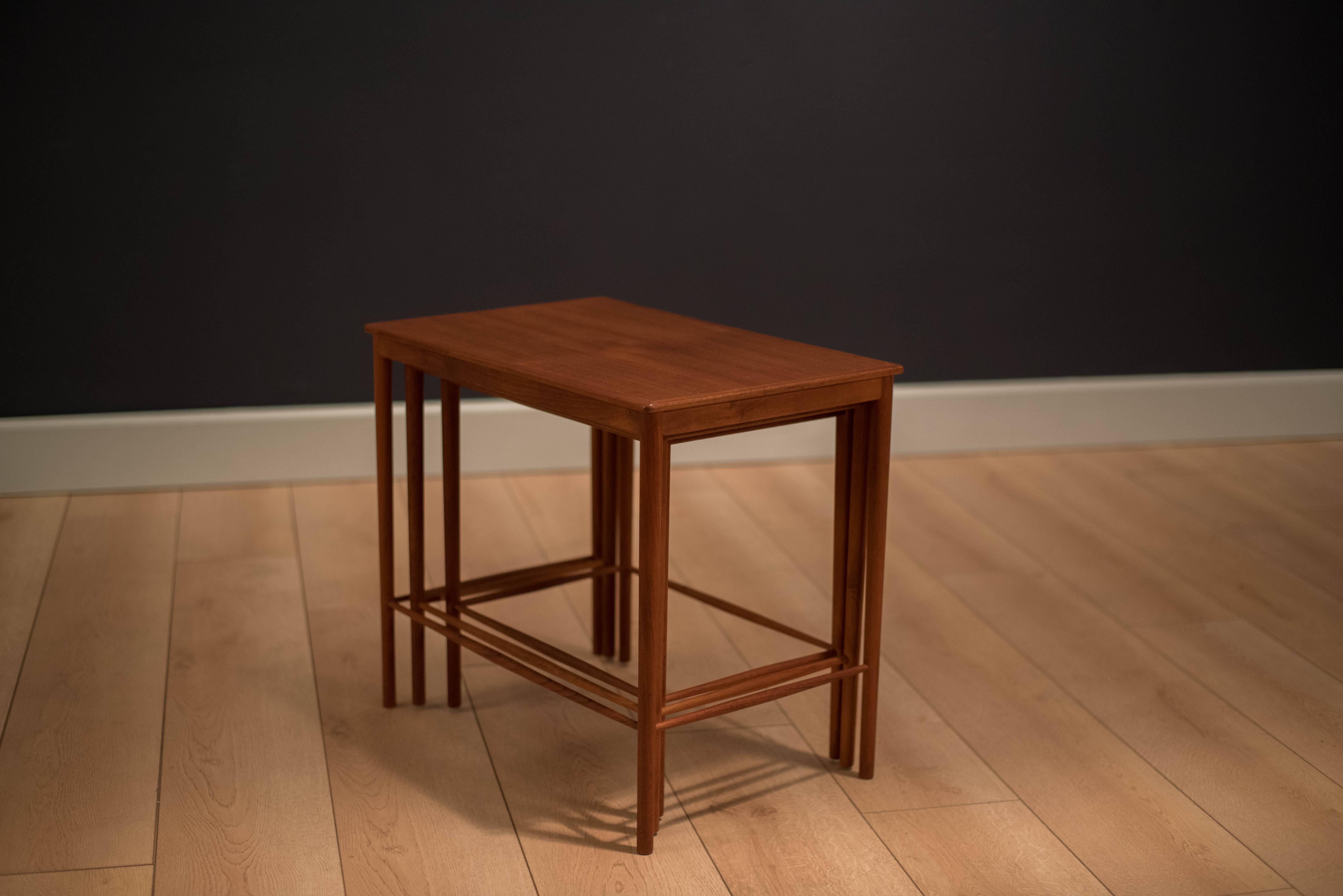 Danish modern teak nesting tables by Ole Wanscher for PP Jeppesen. This set includes three stacking tables and is perfect for any small space.

     