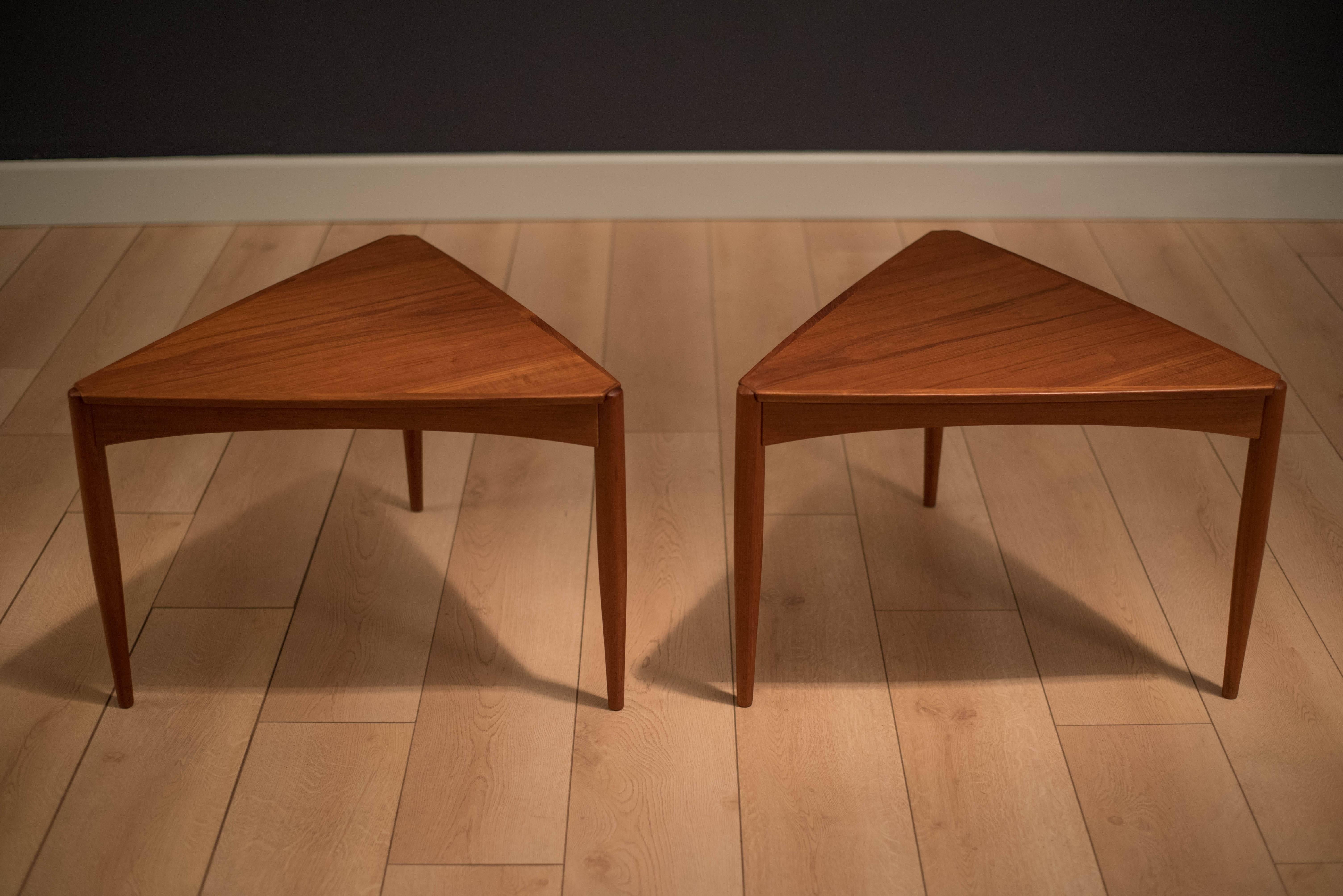 Mid-Century pair of triangle tables in teak, circa 1960s. This set displays opposing teak veneers and sculpted legs. Price is for the pair. 

    
