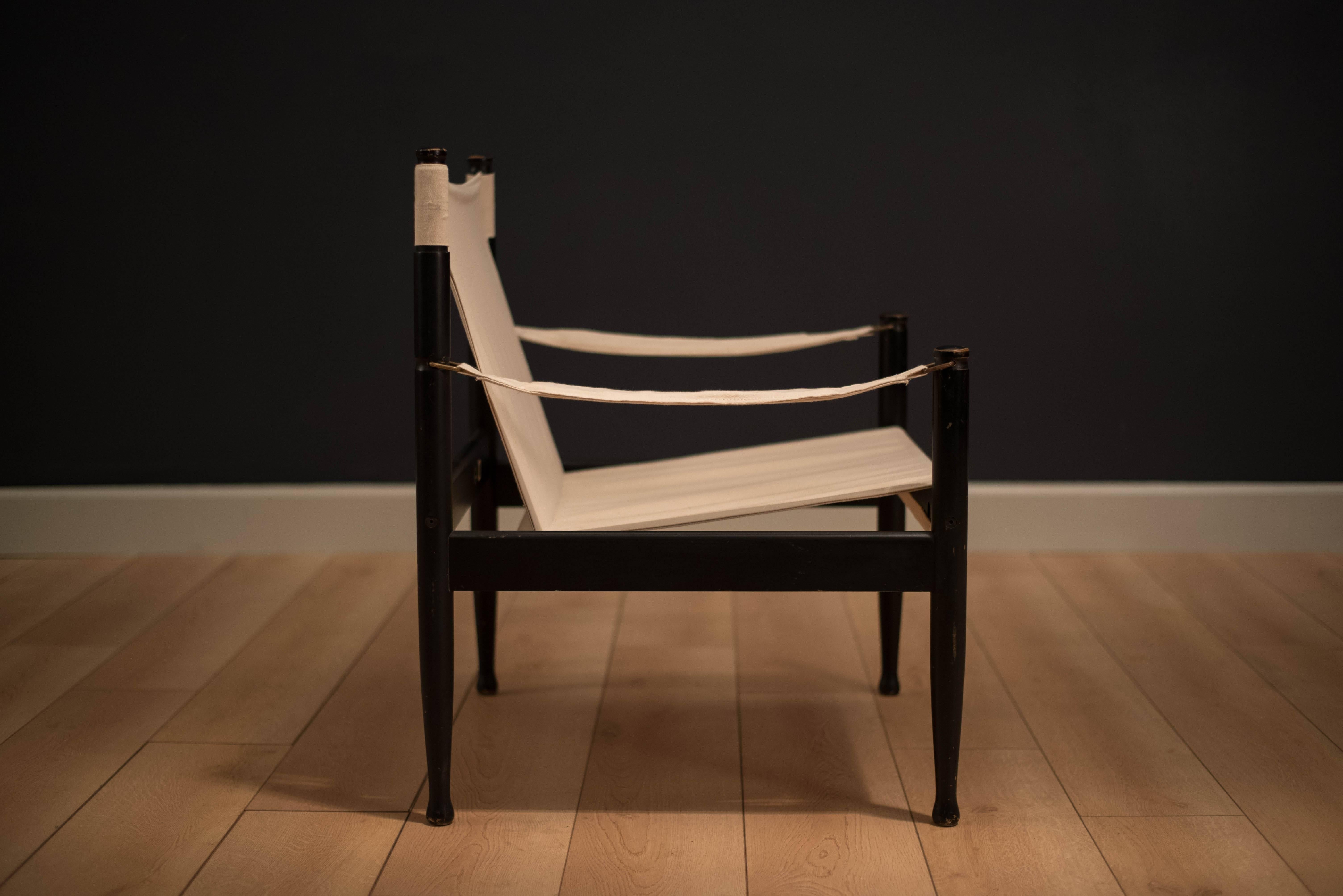 Mid-century Safari chair designed by Erik Worts for Niels Eilersen, Denmark. This piece has been reupholstered in a natural canvas sling. The original black lacquer frame displays some vintage patina.


