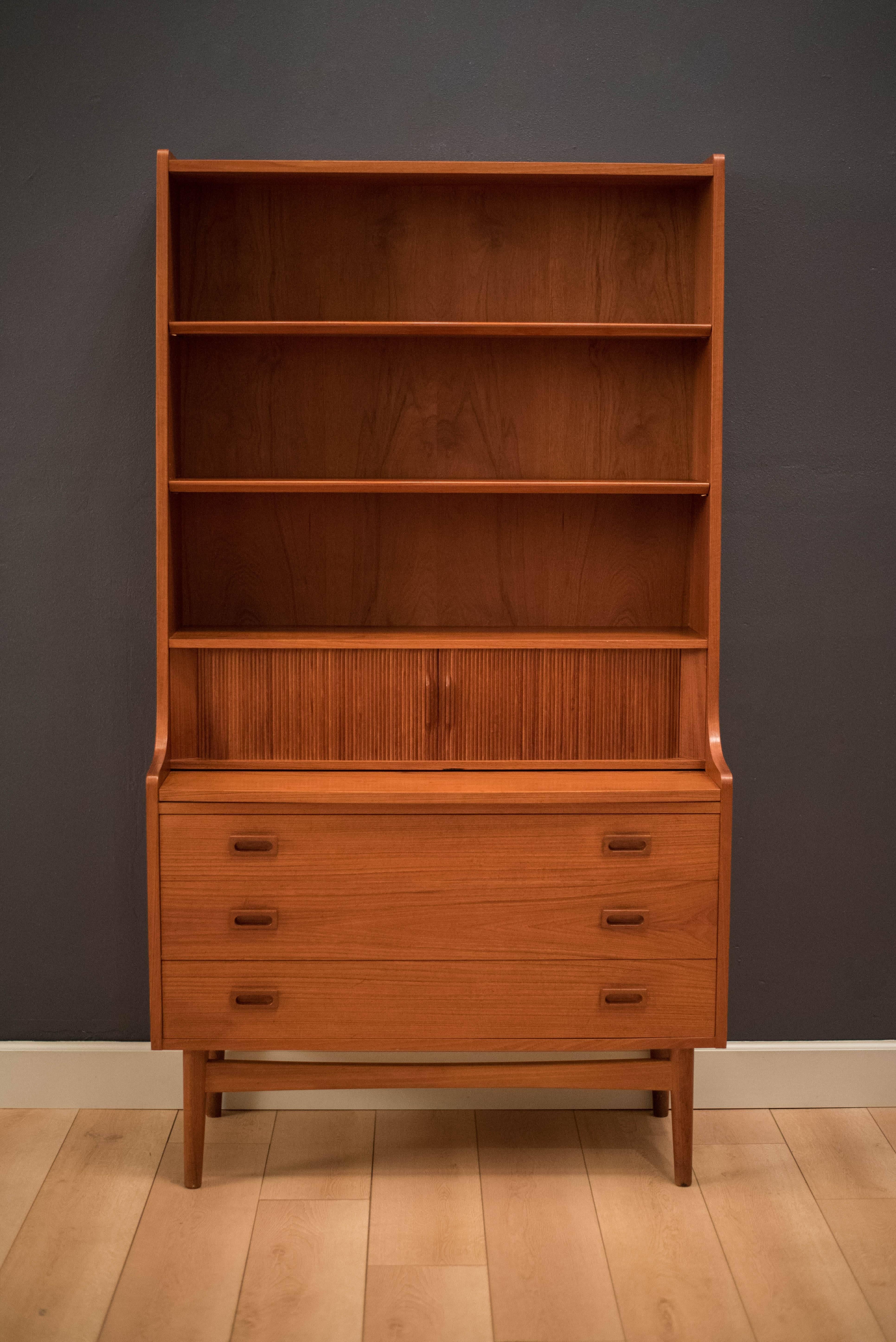 Mid-Century bookshelf secretary desk designed by Børge Mogensen in teak. This versatile piece has three storage drawers and a unique tambour door that reveals smaller storage compartments. Desk slides in/out to maximize space. 

Desk slides out