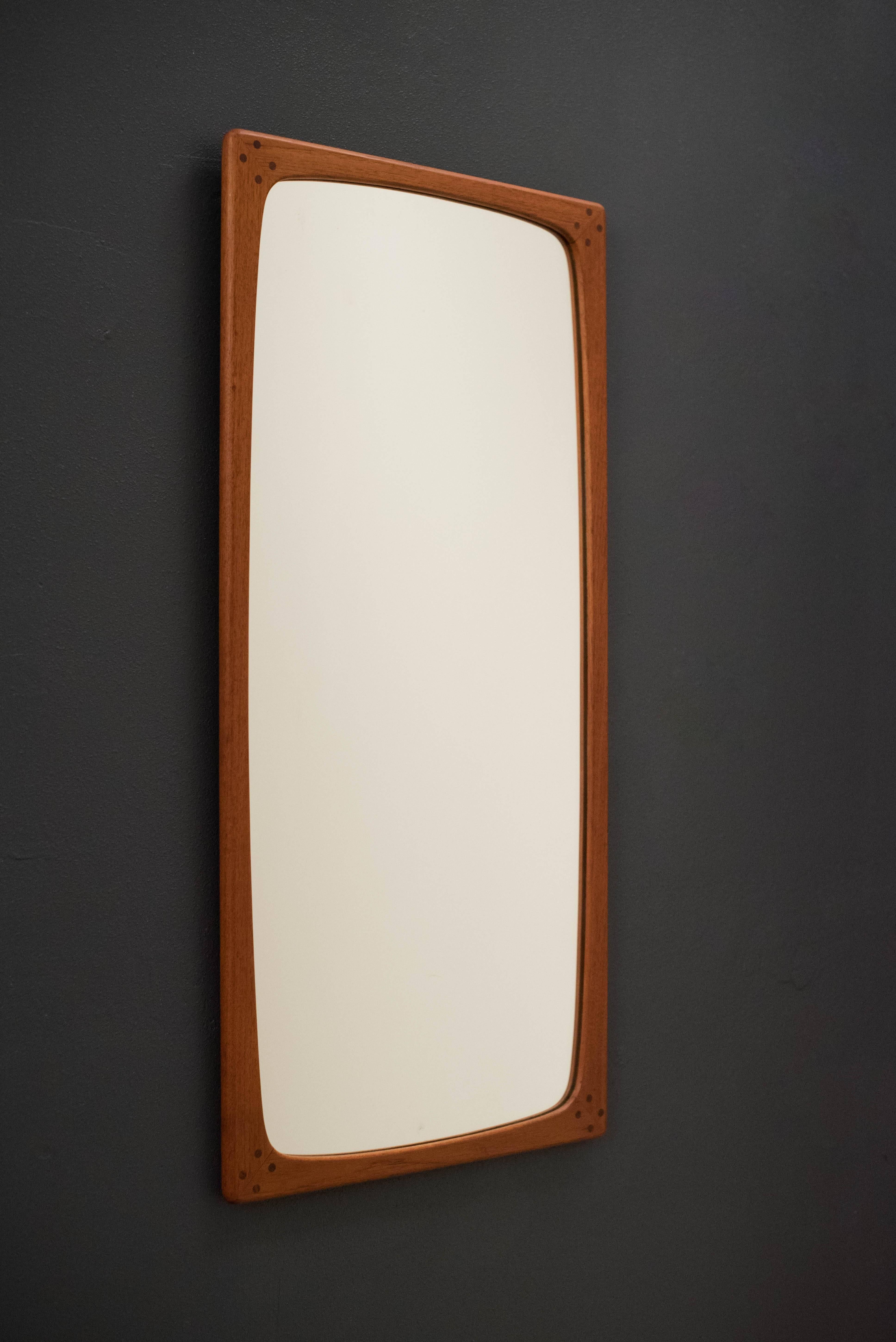Mid-Century wall mirror by Aksel Kjersgaard in teak. This unique sculpted tall mirror is accented with detailed joinery.

                 