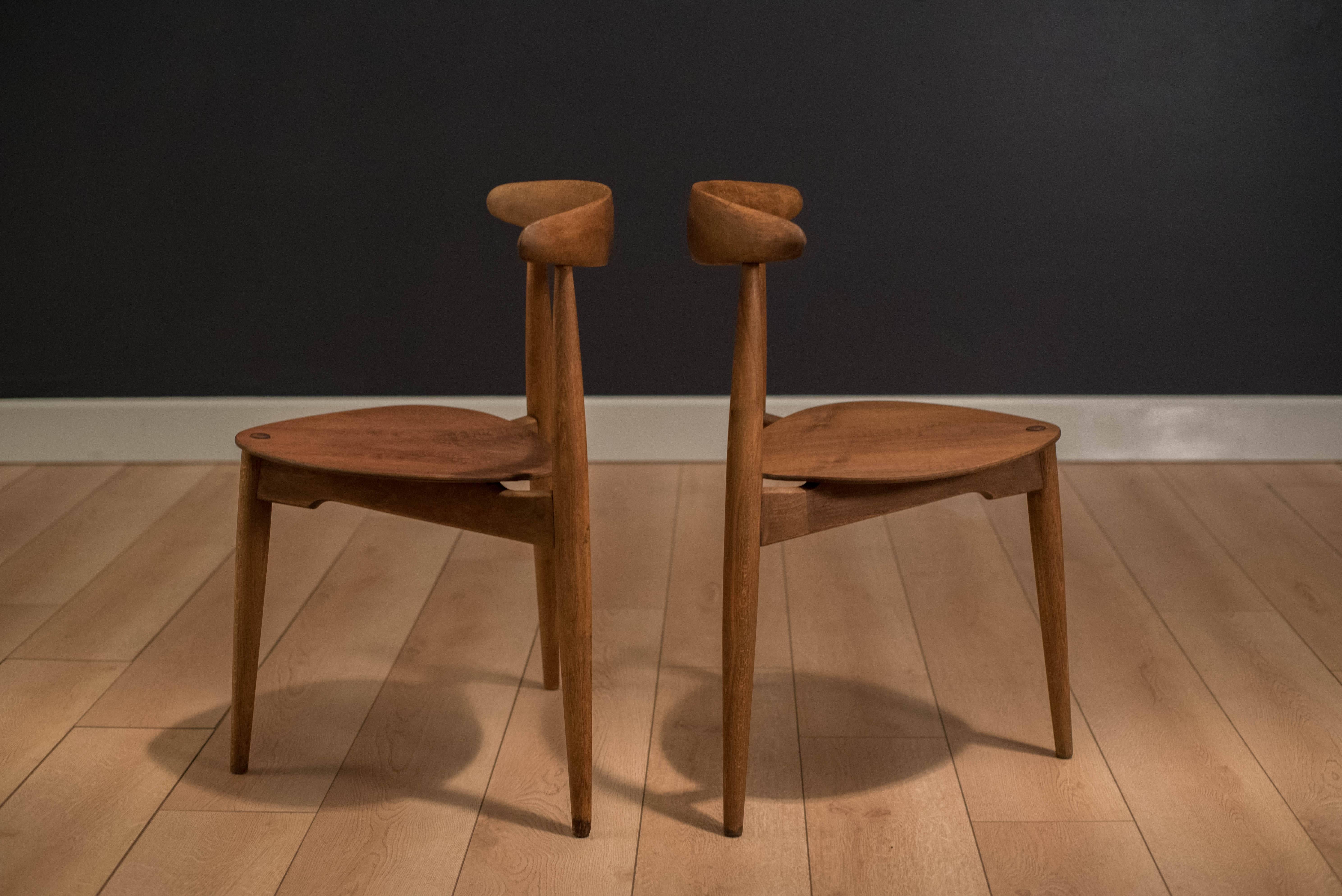 Mid-Century heart chairs designed by Hans J. Wegner for Fritz Hansen model FH 4013. This piece is constructed of teak and beechwood. Imported by Raymor. Price is for the pair. 

