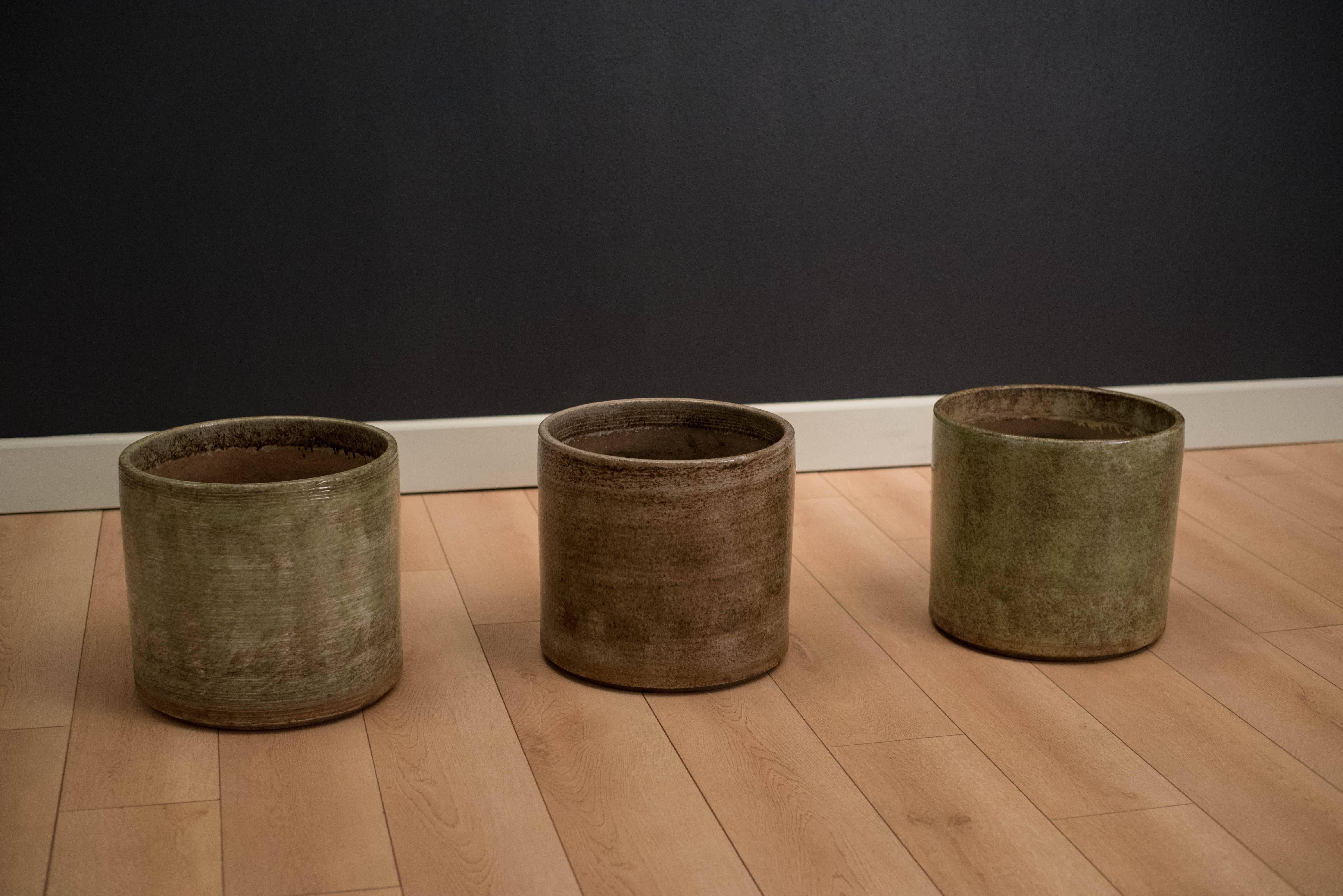 Mid-Century planter pots designed by Gainey Ceramics of La Verne, California. Each piece comes in a high gloss textured finish. Two are available in green, one in a neutral brown tone. Price is for each.
     
    