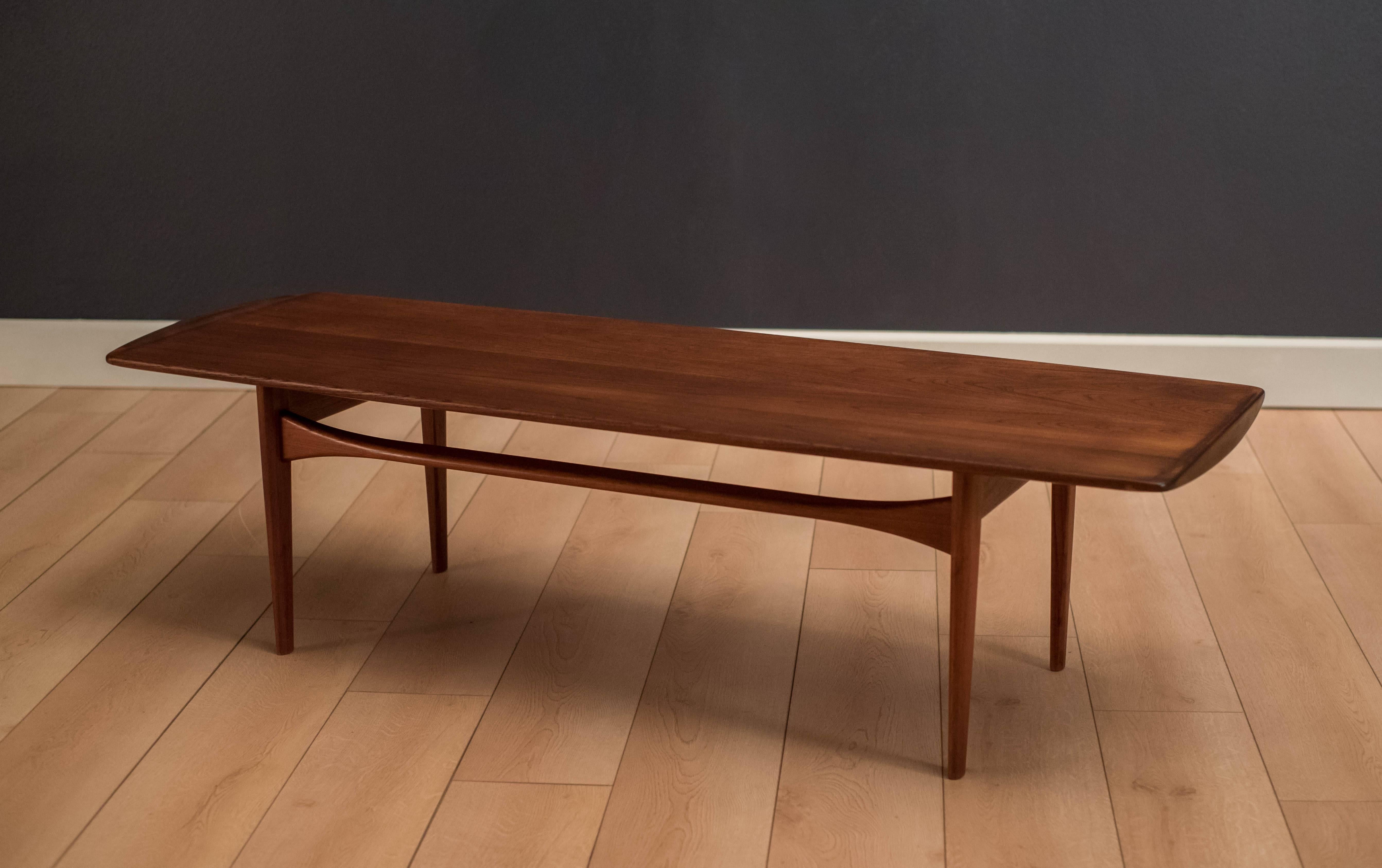 Danish modern coffee table by Tove and Edvard Kindt-Larsen for France & Daverkosen. This piece features a sculptural teak frame and sleek design. 


