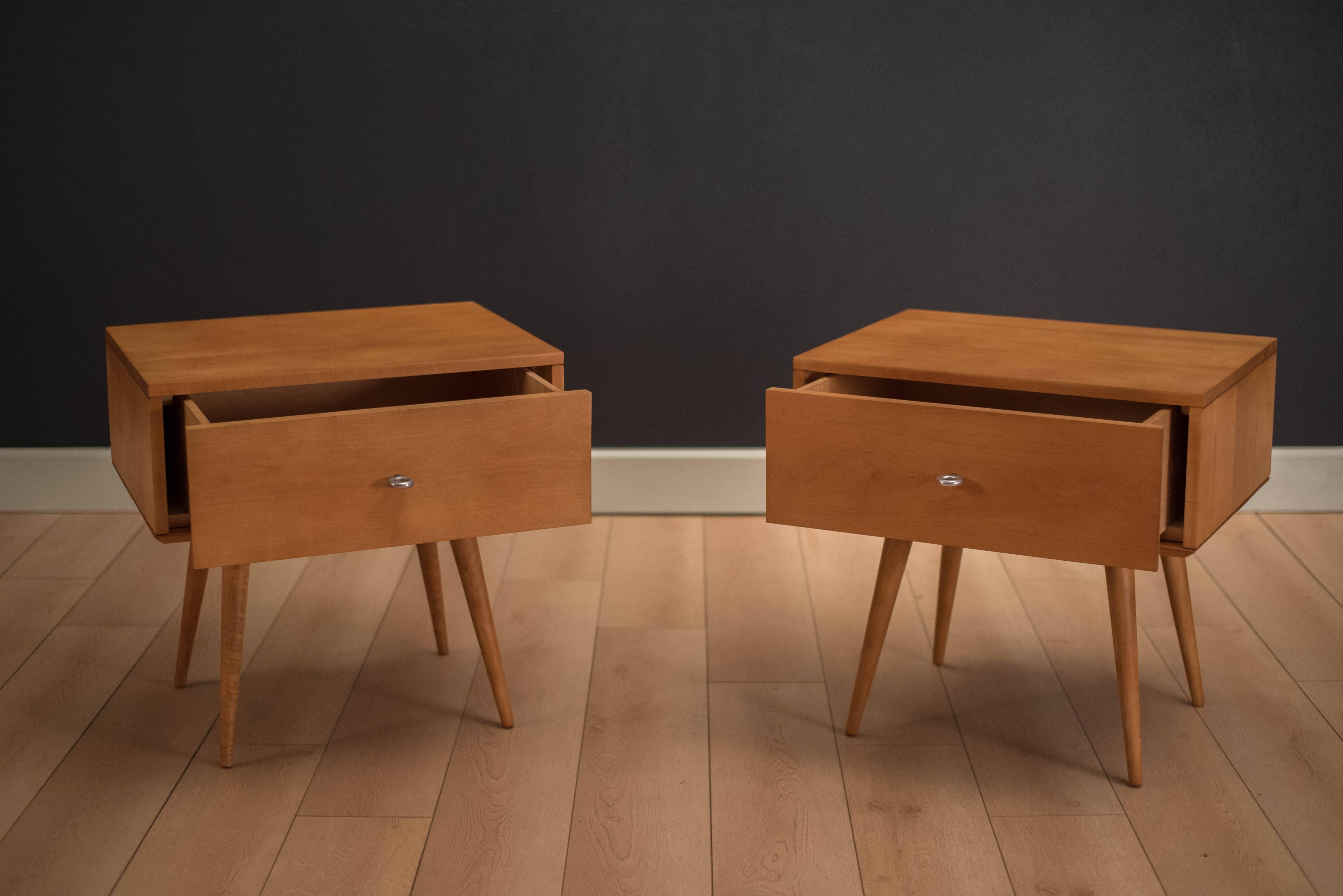 Mid-Century pair of Planner Group nightstands or bedside tables designed by Paul McCobb for Winchedon Furniture. This set is made of solid wood and accessorized with McCobb's signature aluminum pulls. Includes two side tables and two modular