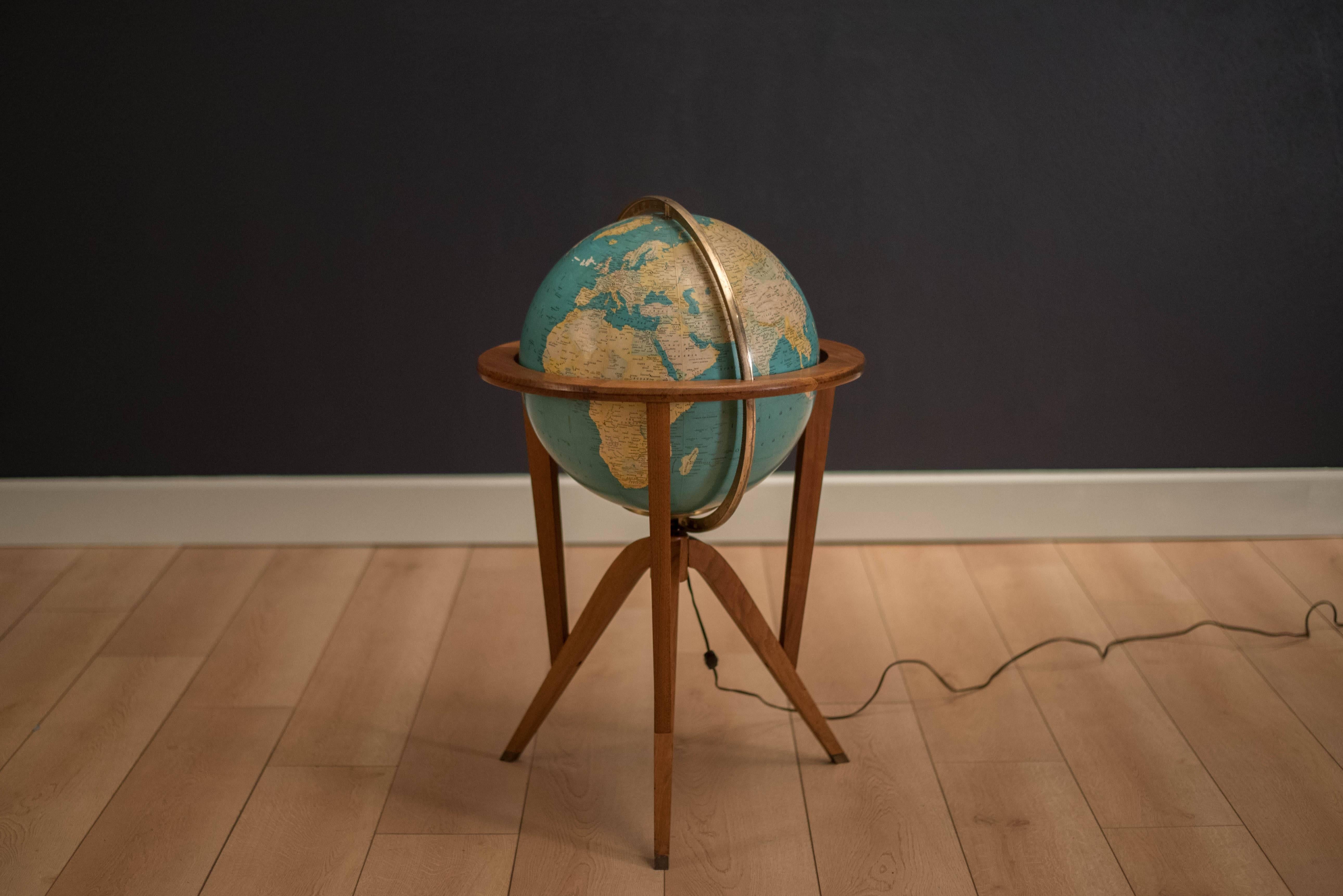 Vintage globe stand designed by Edward Wormley for Dunbar, circa 1950s. This piece features a rotating light up globe made with a solid walnut stand. 

