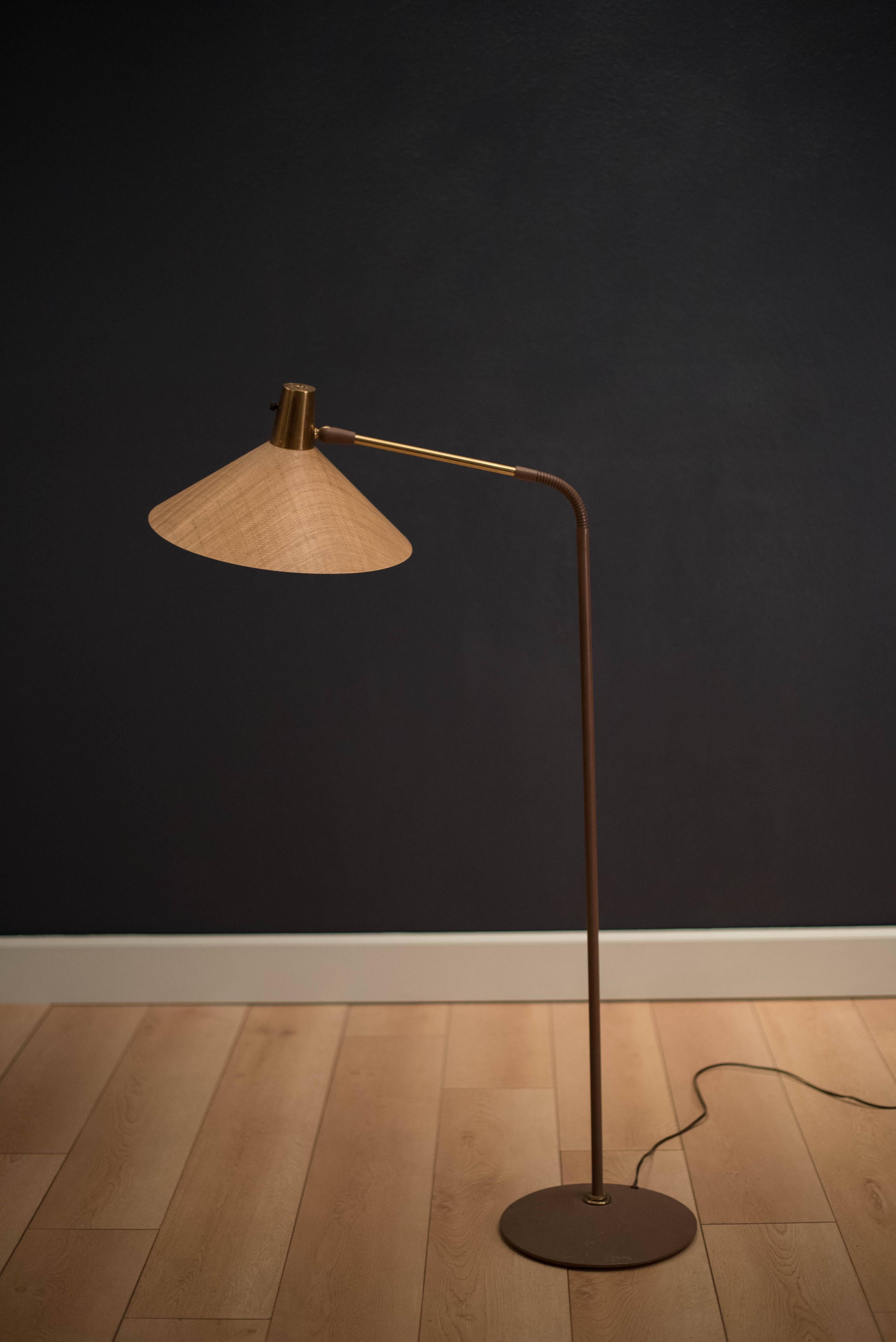Mid-century task floor lamp with fiberglass shade. This piece has an adjustable arm and shade. Includes three way switch.