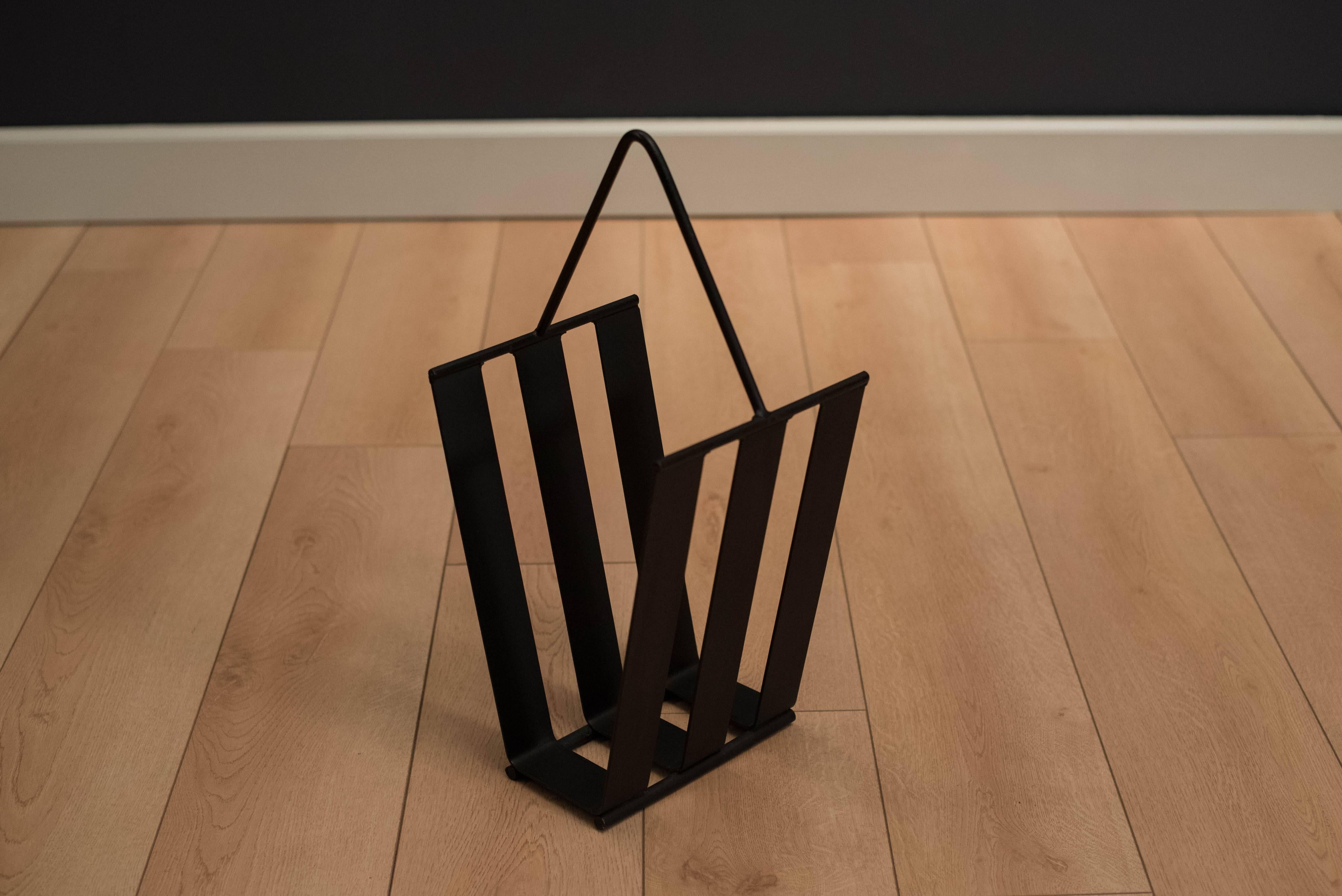Mid-Century magazine holder in black iron, circa 1960s. This piece can hold magazines, books, or lp records.