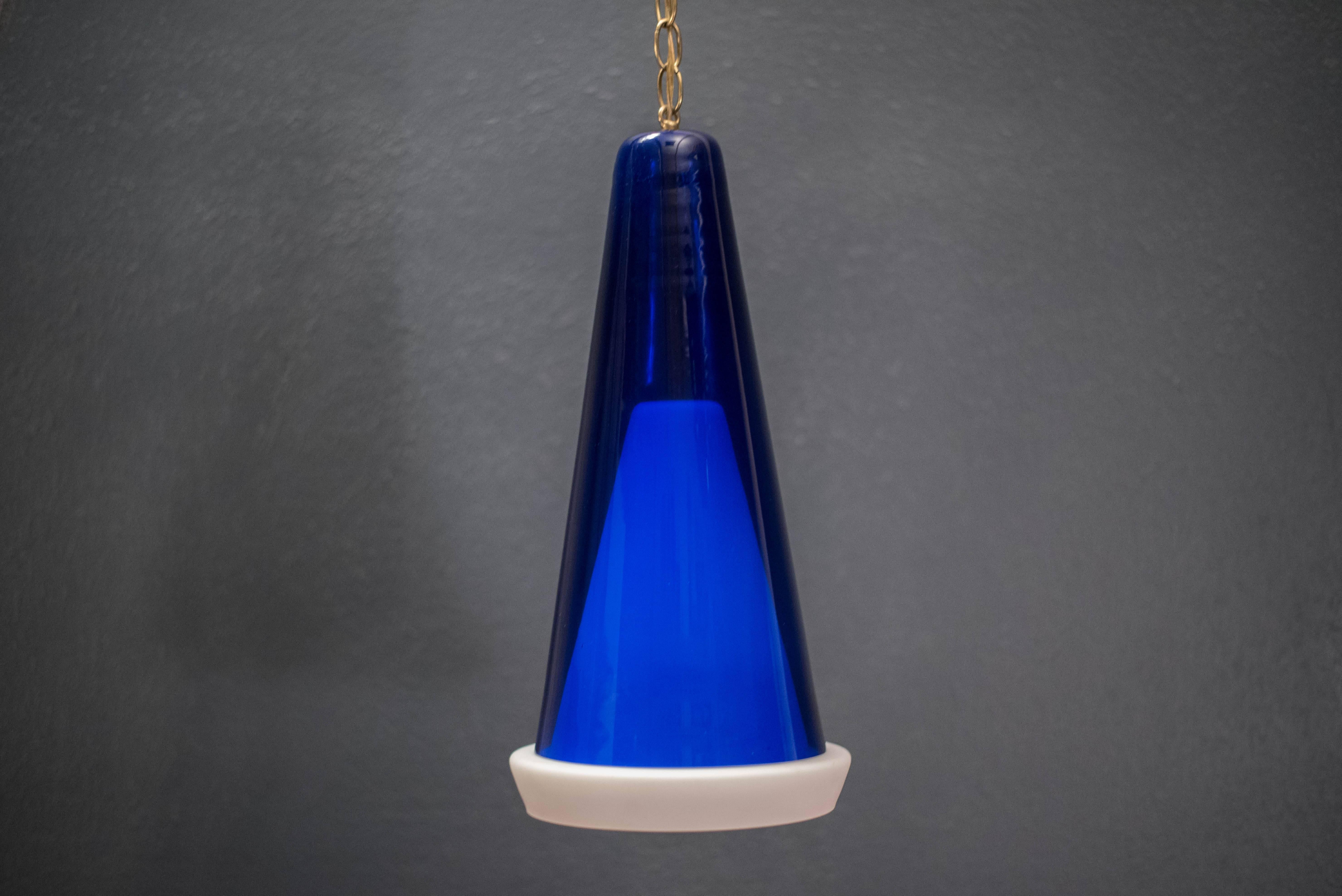 Mid Century Scandinavian pendant lamp, circa 1960s. This piece includes a white frosted pendant with blue glass shade. 

 